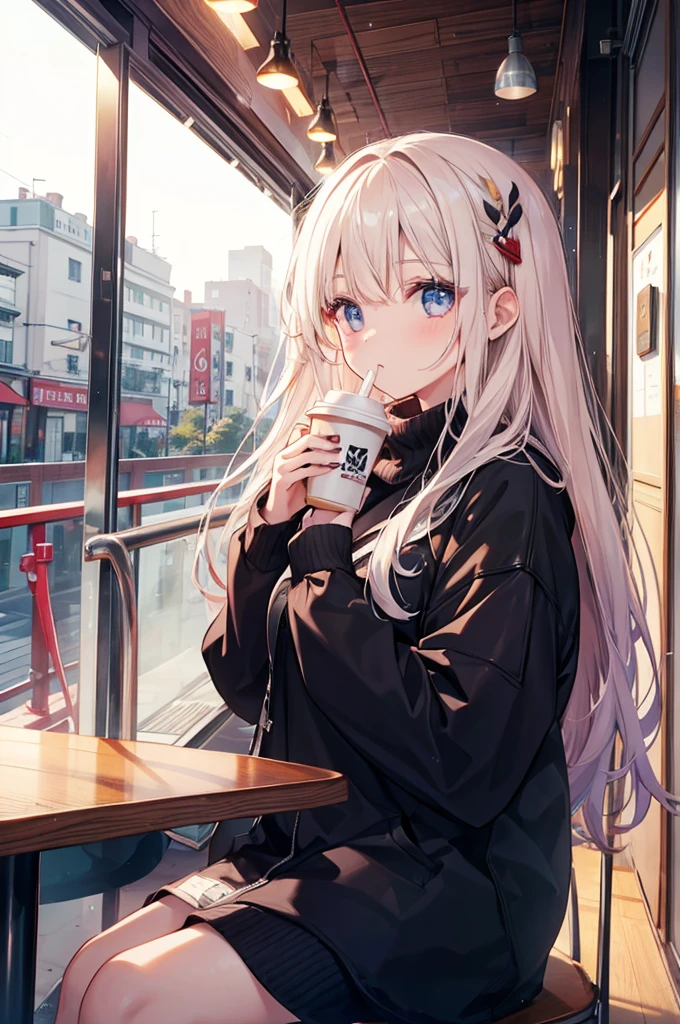 A girl drinks coffee in a cafe on a winter morning。