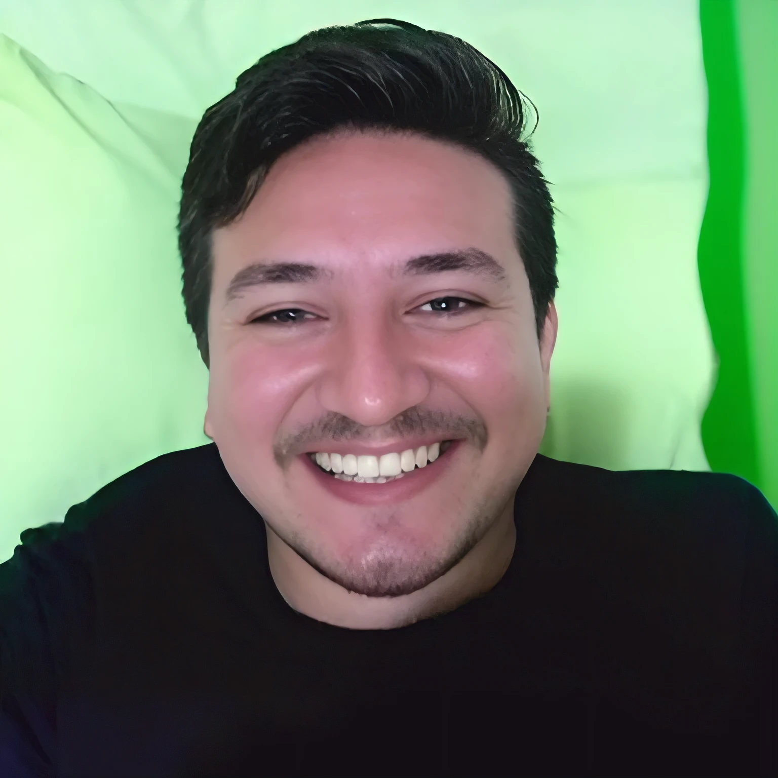smiling man with black shirt and mustache on green background, markiplier, happily smiling at the camera, headshot profile picture, twitch streamer / gamer ludwig, he is smiling, relaxing and smiling at camera, avatar image, smiling male, insane smile, very slightly smiling, smiling and looking directly, halfbody headshot, david rios ferreira, neckbeard, 8k selfie photograph