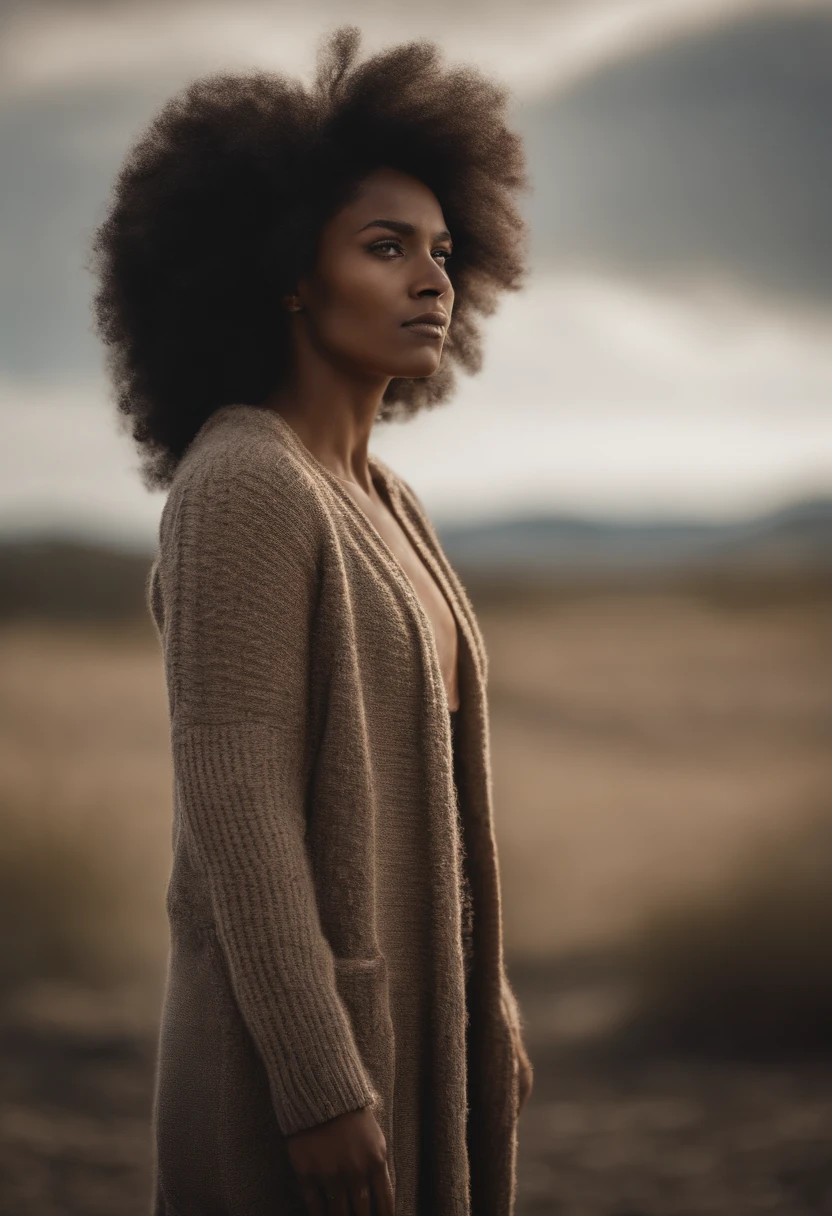 A strong and proud Amazon, warrior woman, with a long cardigan and knitted sweater underneath and a short draped skirt and long curly afro hair, looking with determination towards the horizon