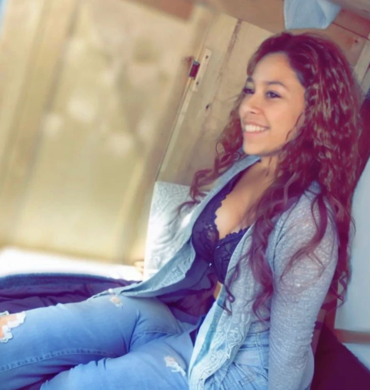 there is a woman sitting on a bed with a blue blanket, age vanessa morgan, alanis guillen, beautiful girl, profile image, sitting down casually, beautiful and smiling, violet myers, taken in the early 2020s, profile picture, vanessa morgan, she is about 1 6 yeadshot profile picture, beautiful surroundings, photoshoot, beautiful gorgeous, Big tits, huge tits, no clothes, sexy, cute, wide hips, thick thighs, pear-shaped body, minimal clothes, thick, bbw, chubby stomach, thick nipples, nipple piercings, large areola, hard nipples, piercing through shirt, nipples hard through shirt, chubby stomach showing, tummy spilling over the side, muffin top, panties only, no pants, pants off, stomach too big for panties, small crop top shirt, major cleavage, nipples showing through shirt, side angle, from the side, sitting, upper body zoom
