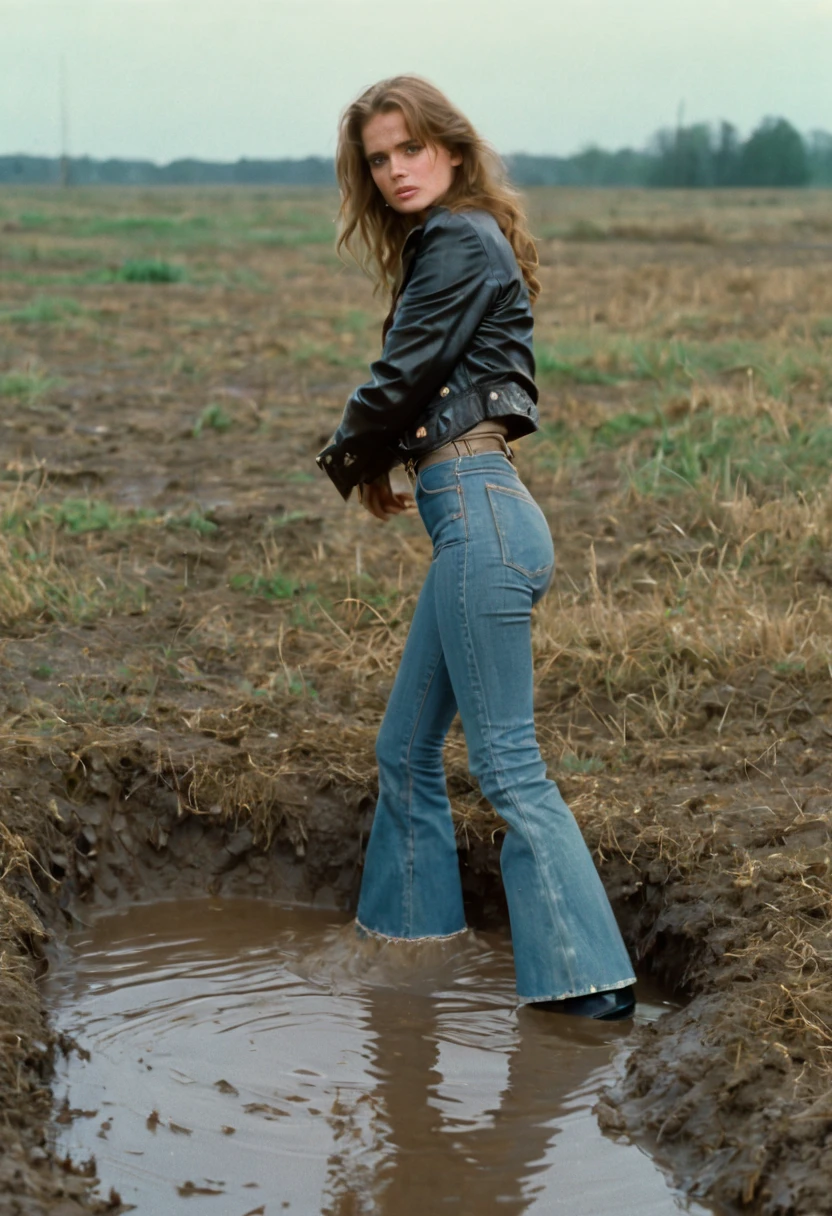 70s setting, film photo of vulnerable girl in worn-out high waist flared jeans and leather jacket and blouse drowning in bog, wet+muddy clothes