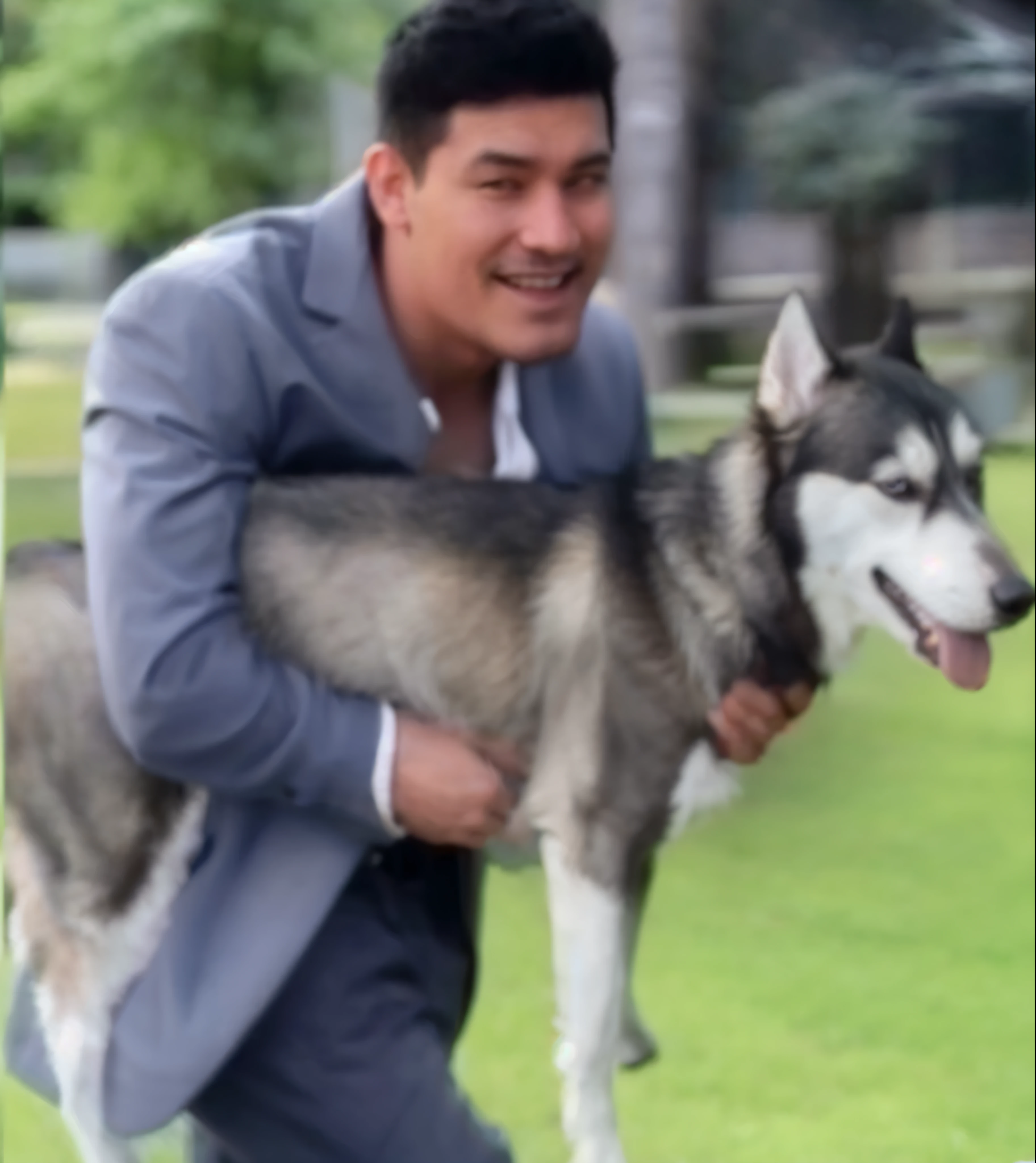 A man holds a dog
