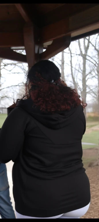 there are two people standing under a shelter talking to each other, photo still of behind view, shot from the back, view from the back, seen from the back, back of the hair, from the back, wearing a black hoodie, with curly red hair, facing away from camera, long dark curly hair, over the shoulder view, in a black hoodie, beautiful girl, big ass, huge ass, bbw, from behind, thick, thick thighs, wide hips, bbw, big tits, sideboob, giant ass, back view, big butt, round butt, tight underwear, underwear halfway off, underwear taking off, grabbing ass, ass spilling over underwear, too thick for clothes, looking left, leftwards, latina, from behind