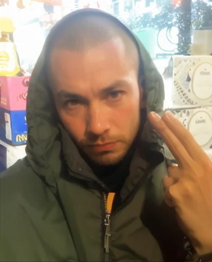 Close up of a face of a man in a green jacket, showing two fingers pretending it's a gun by his head, taxi driver movie color palette, city underground vibe, lost, no future, skinhead, numb eyes, bom,  8k selfie photograph, patryk hardziej, aphex twin, Michael Gira 