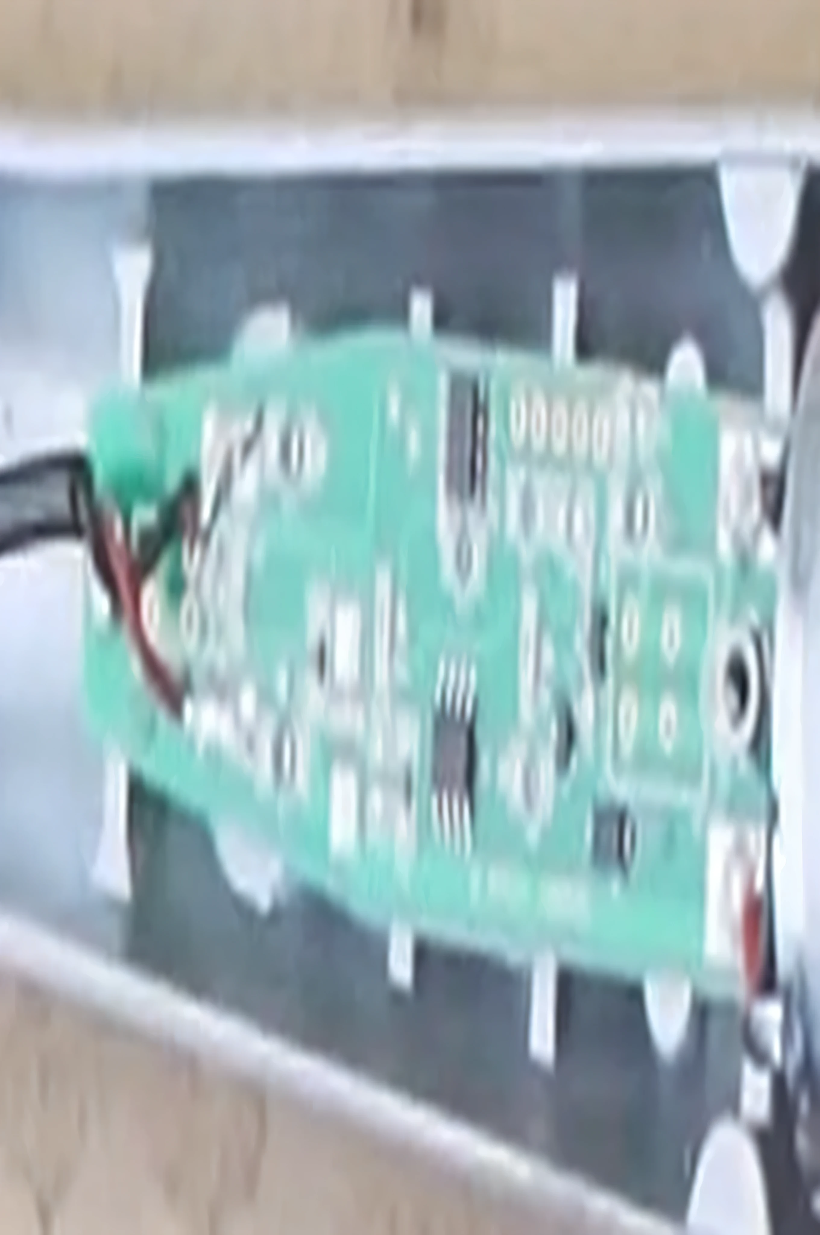 a close up of a green electronic device with a black wire, circuit board, circuit boards, circuit board artifacts, printed circuit board, assembled, [ overhead view ]!!, motherboard circuitry, electronic case display, overhead shot, top-down view, top - down view, top view, prototype, [ overhead view ]!, circuitry, circuit boards)))))