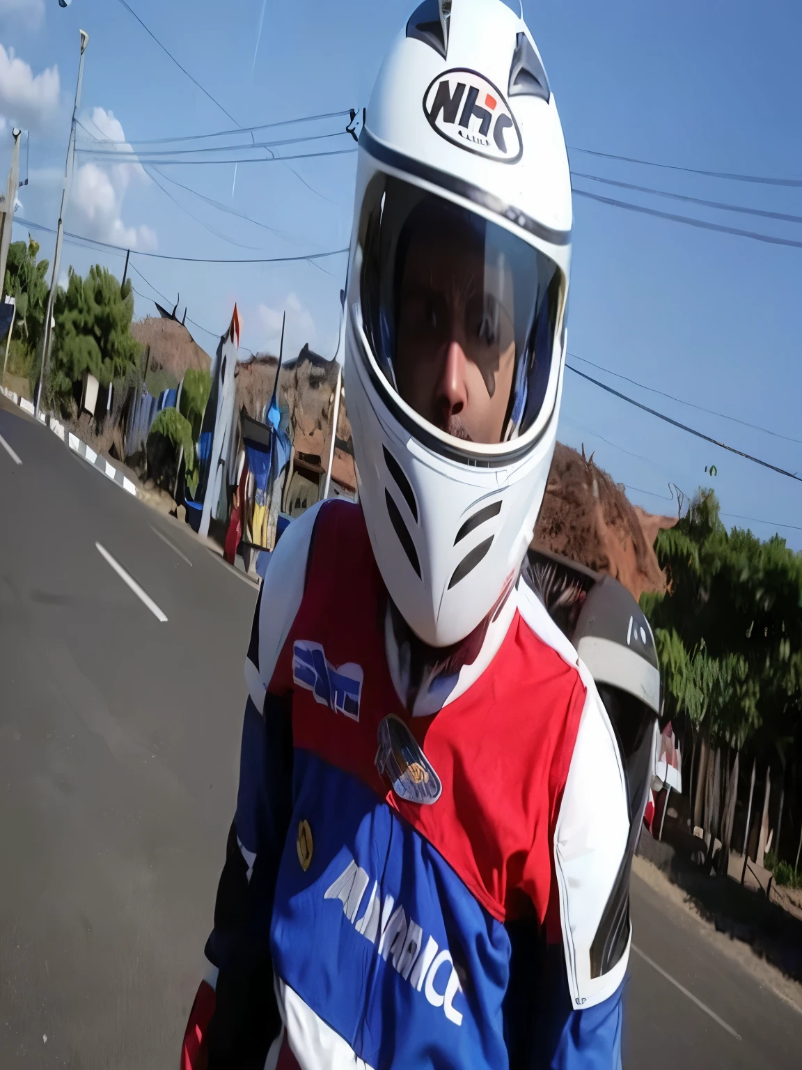 arafed man wearing a helmet and a blue and red shirt, wearing helmet, wearing a round helmet, no helmet, no helmet!!!!, wearing a helmet, helmet on face, without helmet, at racer track, helmet on, helm, biker, wearing an elaborate helmet, andy worhol, motorbiker, racing, portrait!!, wearing winged helmet
