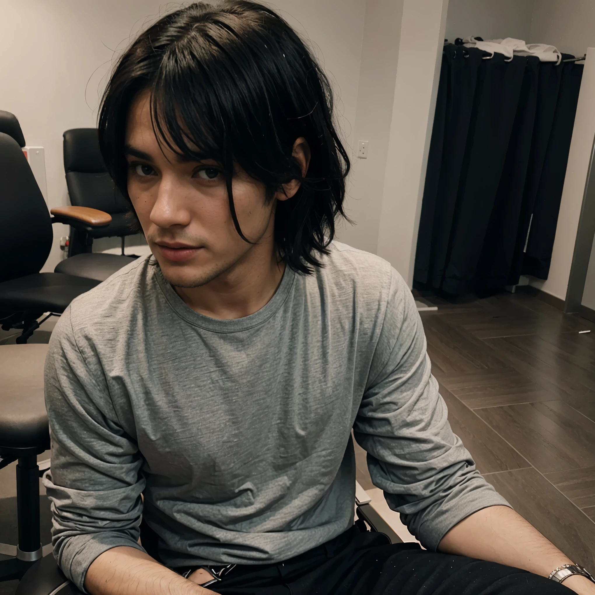 black haired man sitting on a chair