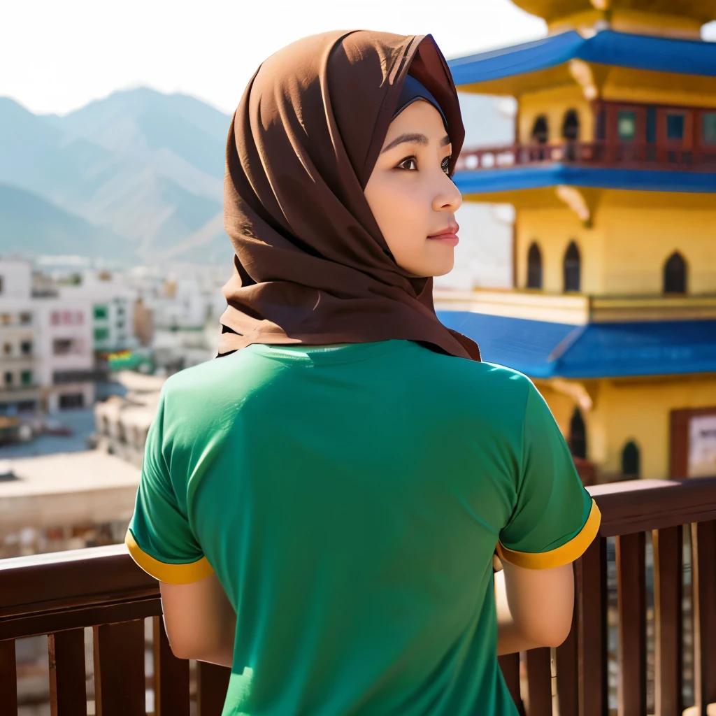 Muslim woman wearing a brown t-shirt that says "Panggabean", her back to the camera, looking at the view of a very old and colorful city
