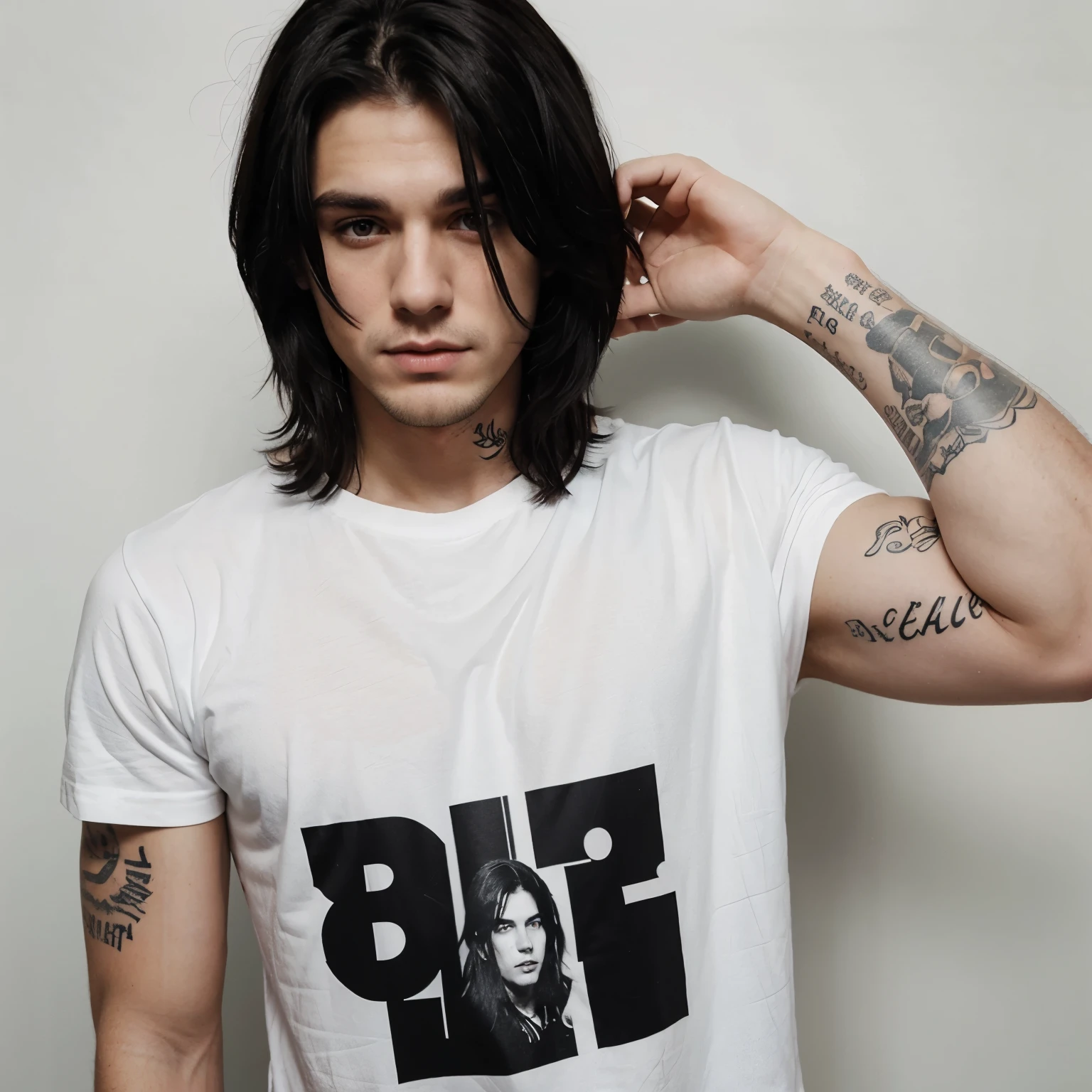 The face of a 25 year old white man with medium length black hair and tatoos on his arms and a black shirt