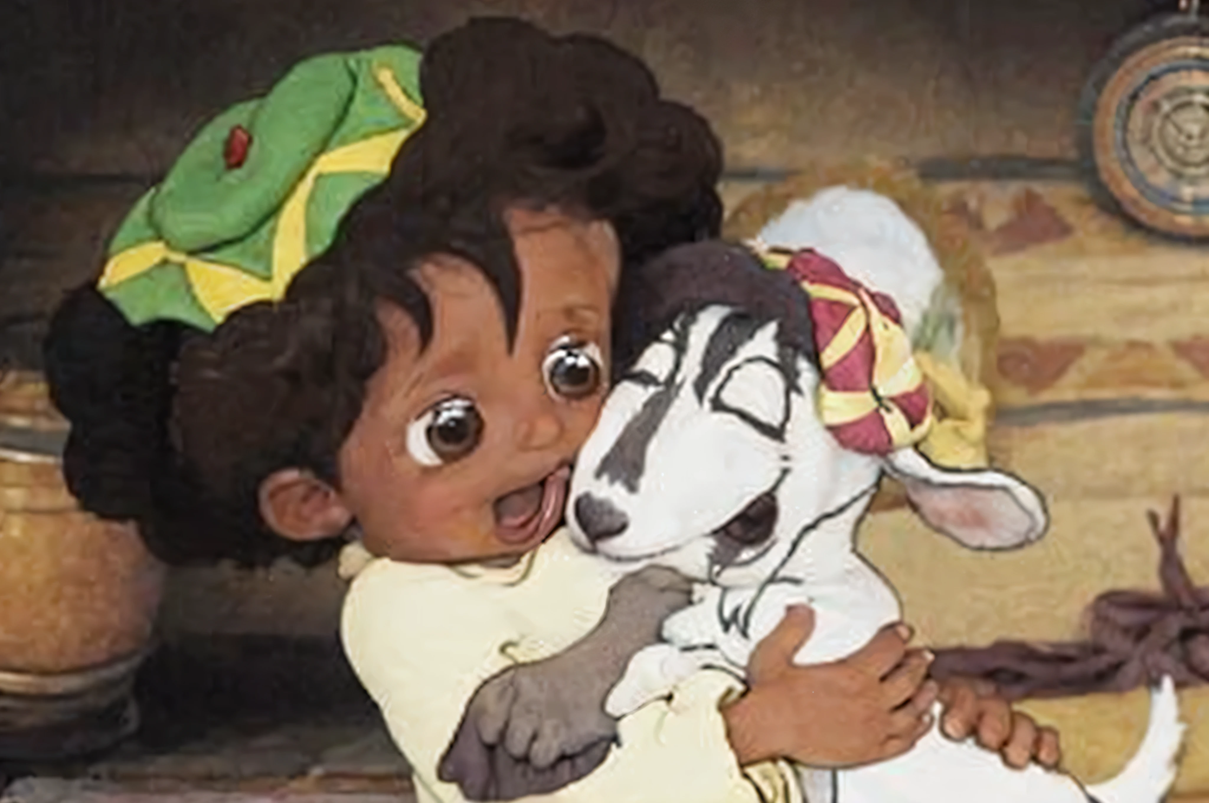 a young brown boy with an afro hugging a baby goat wearing a colored hat