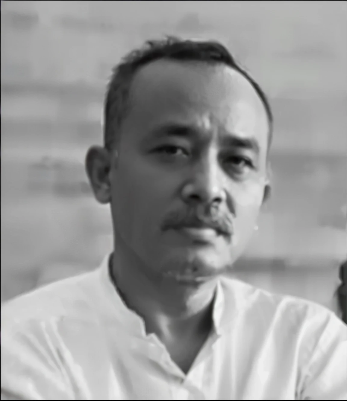 Infonesian male , age 45 years old, wearing chocholate shirt, pretty chubby, black shortcut hair, dark background