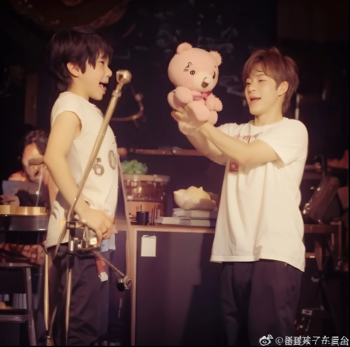 The boy on the left is in profile,Grimacing,Open mouth and eyes wide,hands on hips,Inhale and lift your chest,The boy on the right is holding a bear doll in both hands