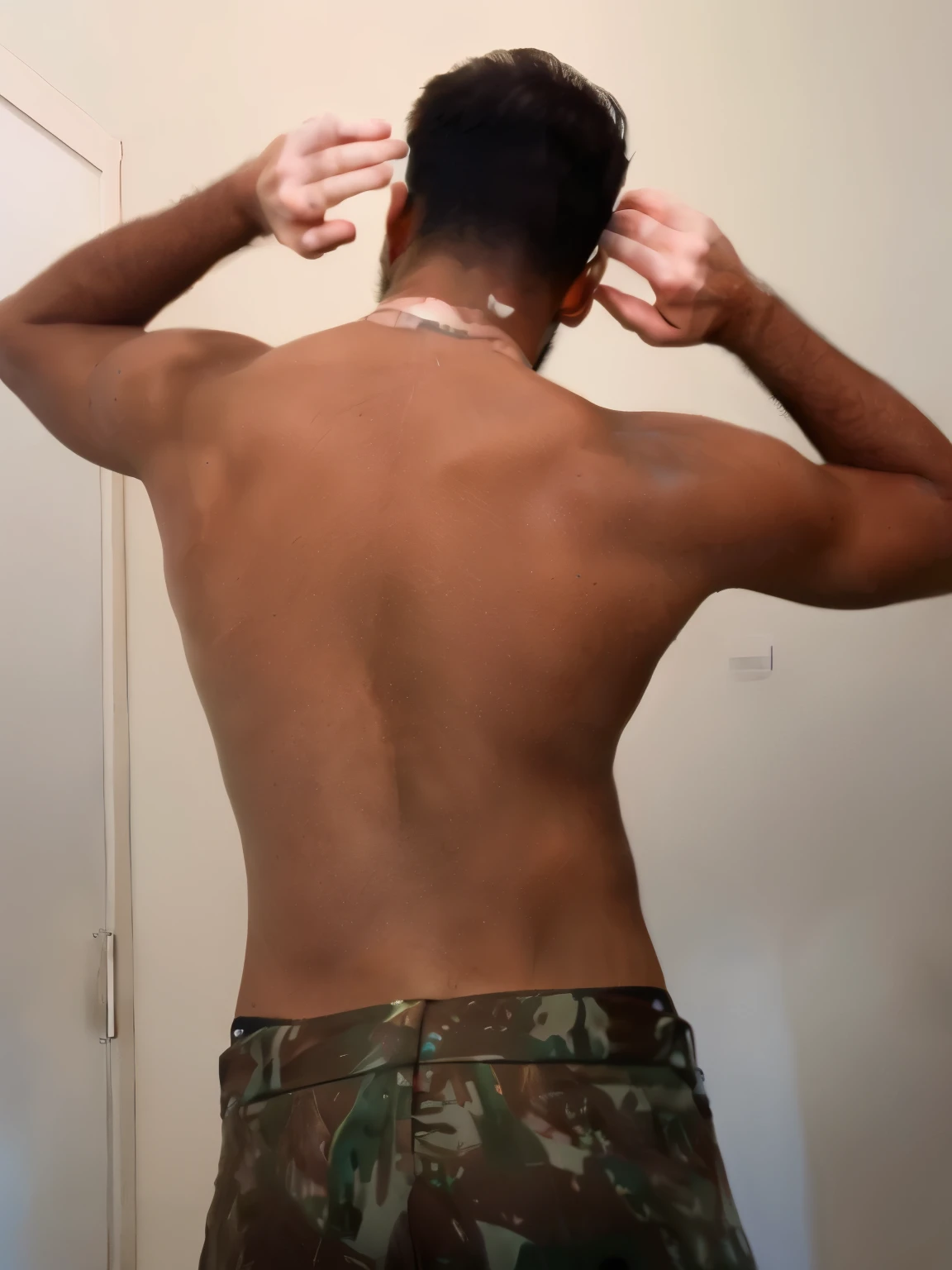 there is a man that is standing in front of a mirror, arms behind back, full growth from the back, his back is turned, back pose, in full growth from the back, shot from the back, from back, 3 / 4 view from back, backview, bare back, his arms are behind his back, with his back turned