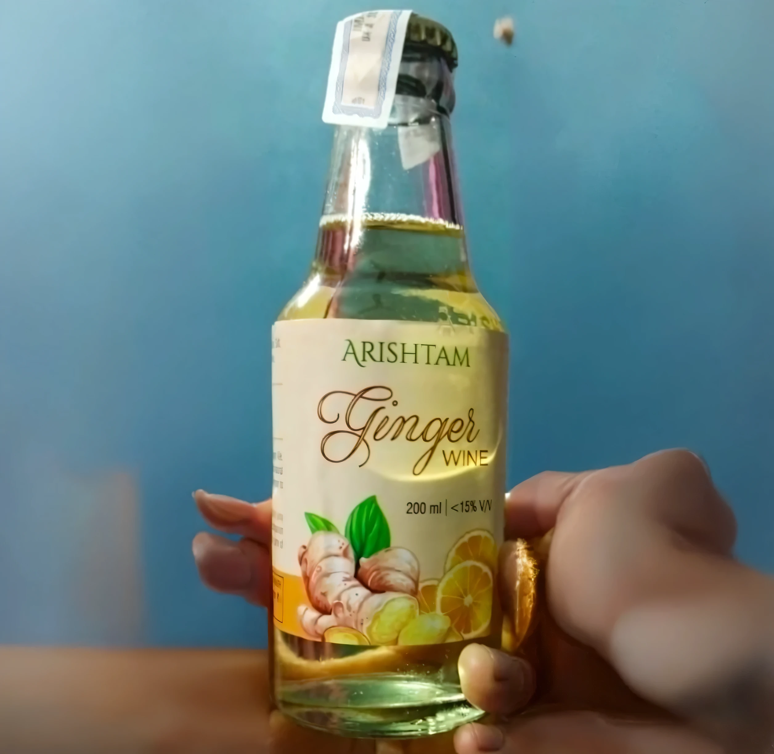 create a square size image and fill in the blank spaces with a person holding the bottle. this image is needed for product placement and marketing