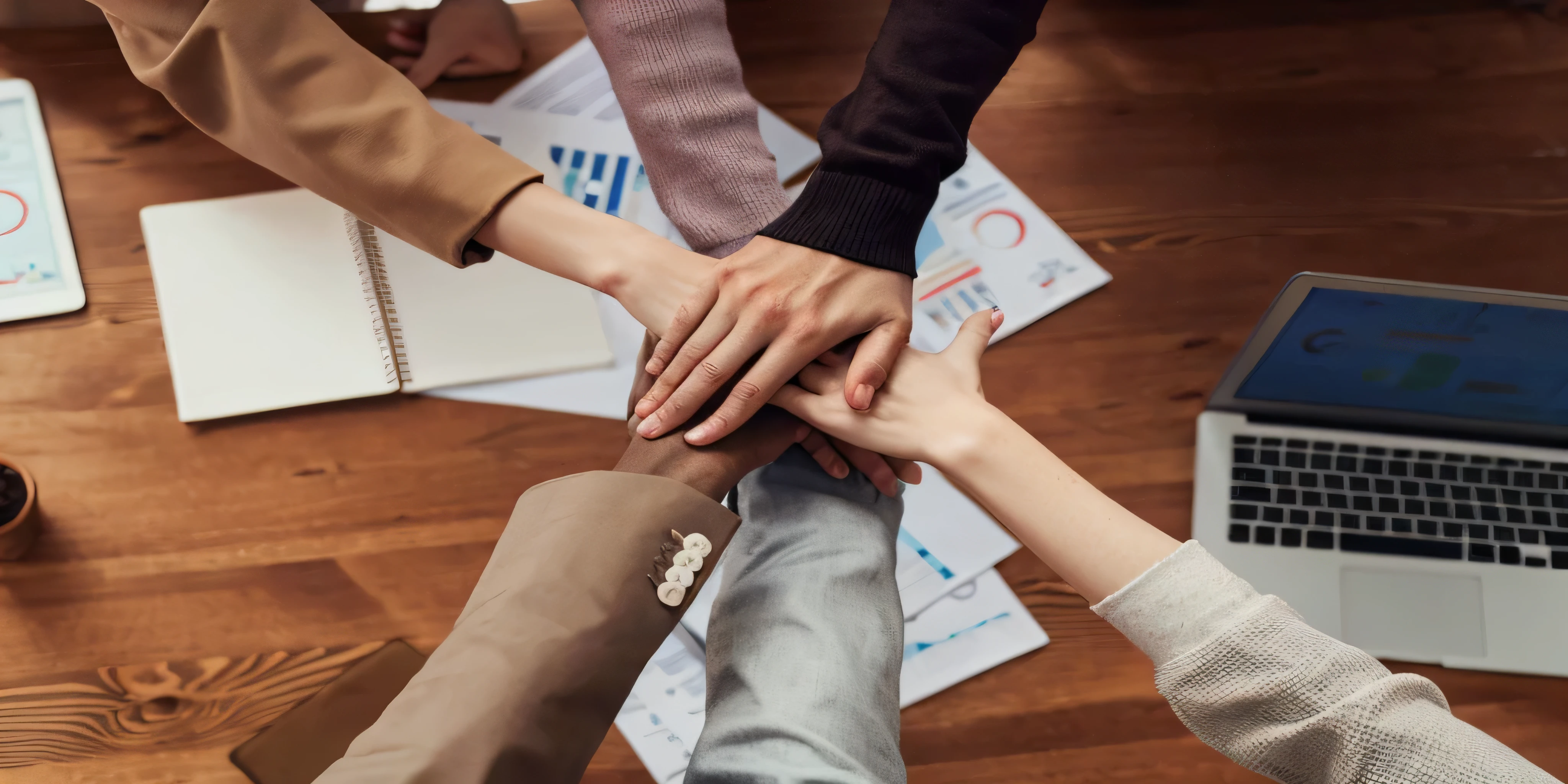 several people are holding hands in a circle on a table, bringing people together, too many hands in all directions, on a dark background, a harmonious integration, hand holdings, hands pressed together in bow, many hands, collaboration, shutterstock, collaborative, diverse, pexels, hands with five fingers, integration, professional, endless collaboration with ai, a group of people