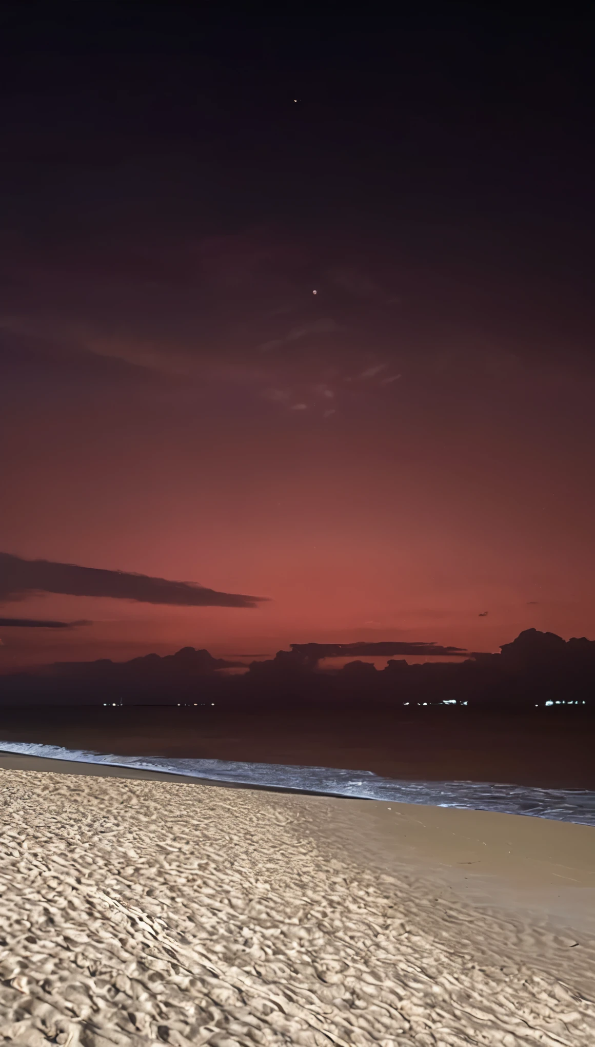 there is a red sky over the ocean and a beach, the sky is a faint hazy red hue, redpink sunset, beautiful and spectacular twilight, Red glow in the sky, pink sunset hue, pink sunset, blood red sky, pink skies, Red sunset, beautiful dusk, with vibrant sky, mysterious red sky, there is midnight sunset, heaven pink, red skies