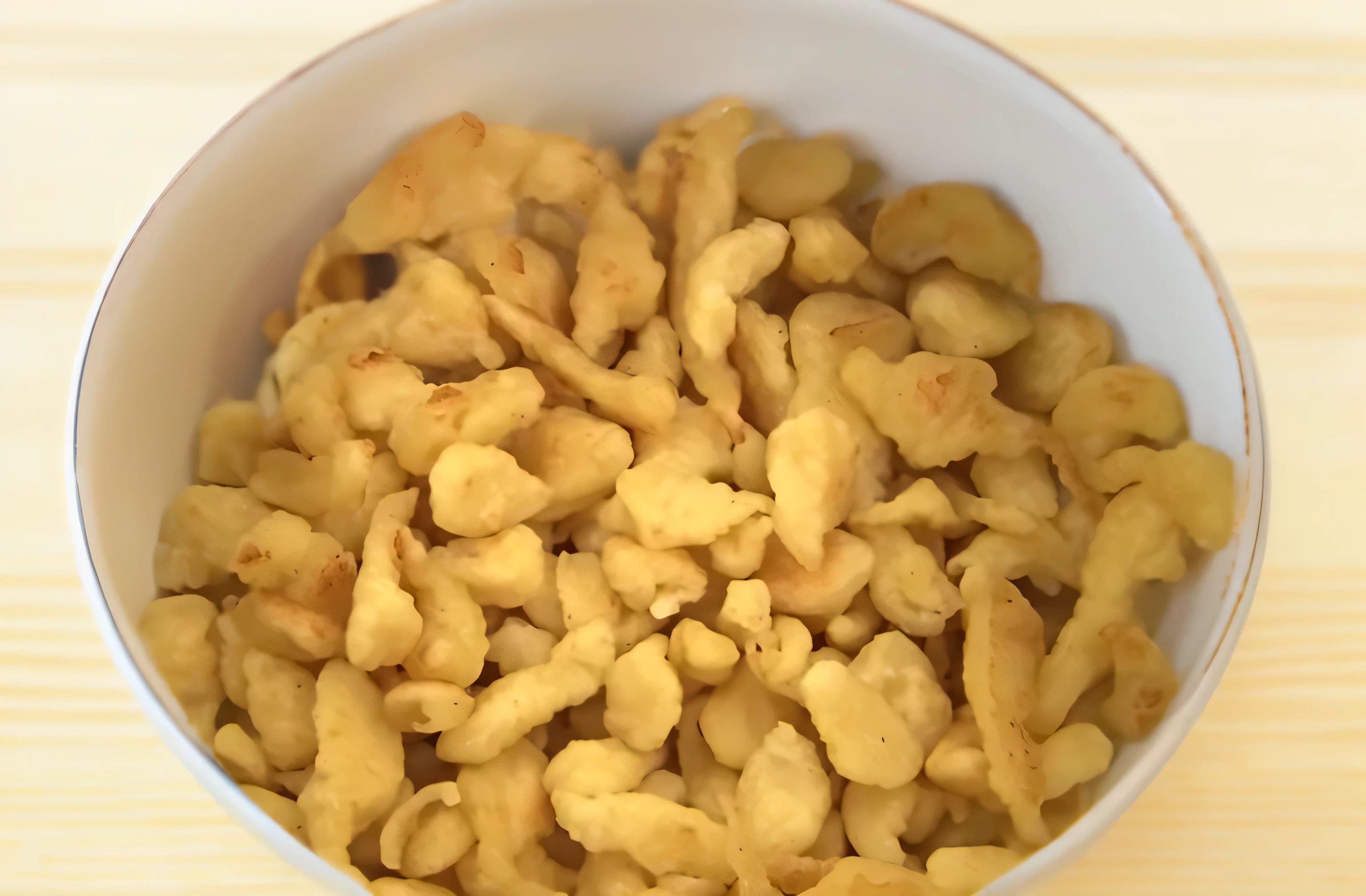 there is a bowl of fried food that is sitting on a table, very crispy, cereal, 4 0 9 6, beans, chicken nuggets, illinois, crispy quality, centre image, yum, very grainy, mixed art, bowl, chips, crisps, chicken, very very surreal, corn, cheerios, dish, snacks, iowa, goldfish