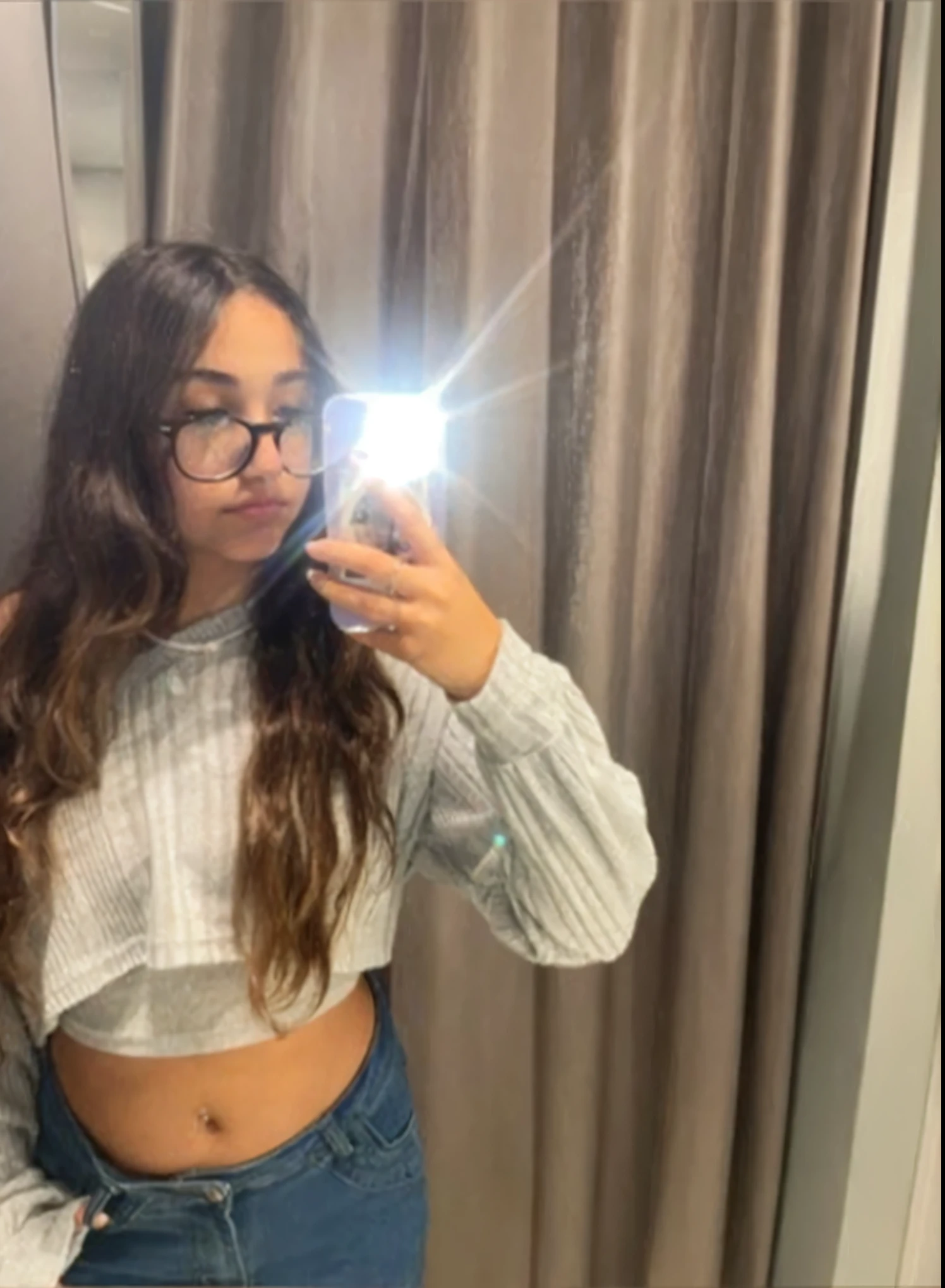 Teenage woman taking a selfie in a mirror with a cell phone, , profile image, violet myers, her belly button is exposed, taken in the early 2020s, 4k quality, glasses, beautiful teenage girl, crop top, belly exposed, top quality