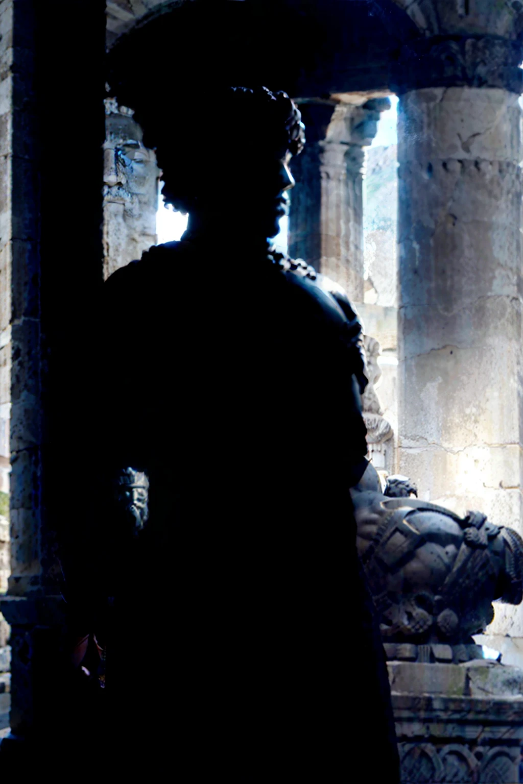 A dark landscape image of an ancient greek society deeply connected to stoicism, black and white, ancient greek architecture, include one single big statue of a stereotypical strong greek man, marcus aurelius --ar 16:9