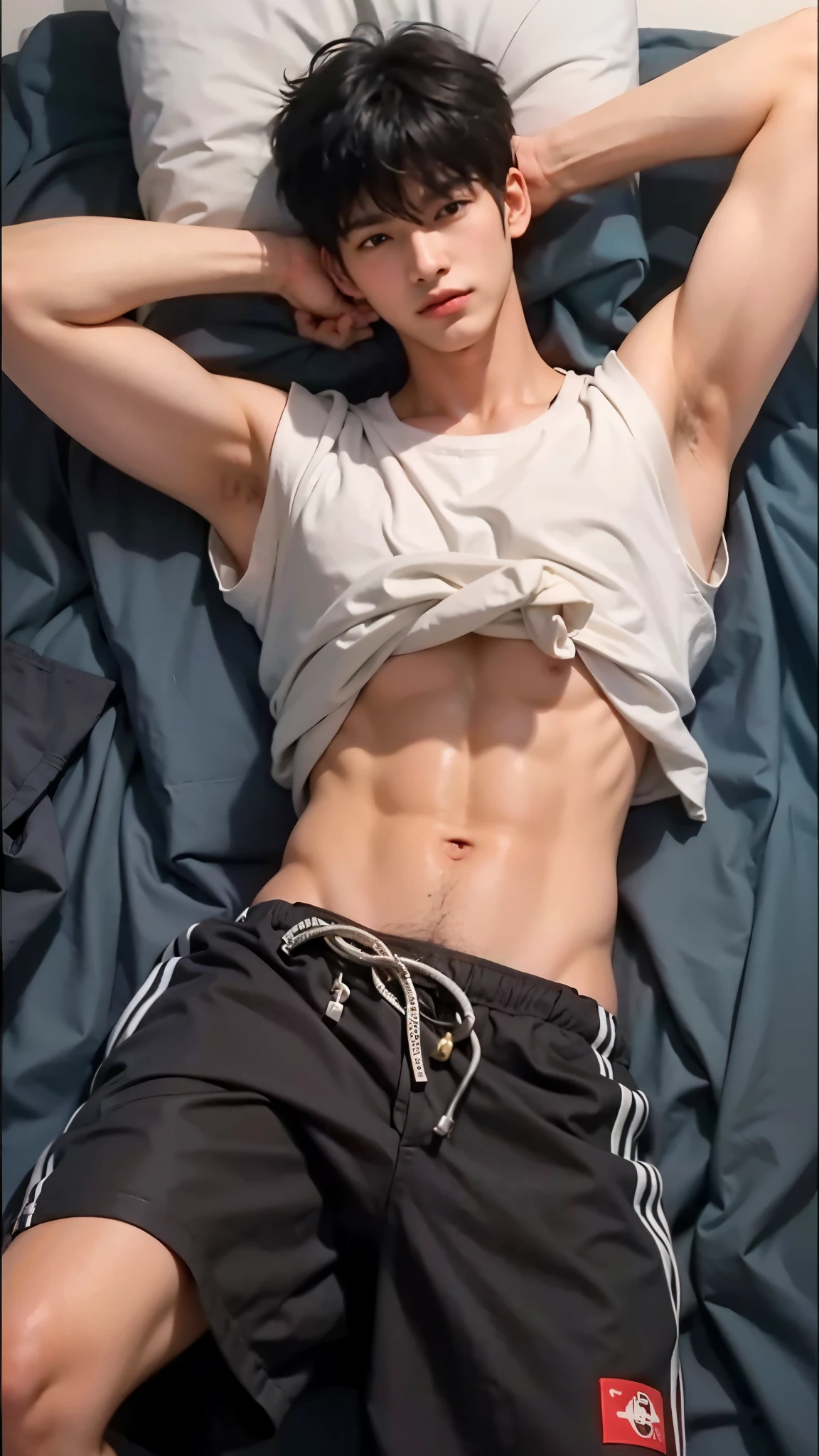 Boy lying on bed with shirt pulled up