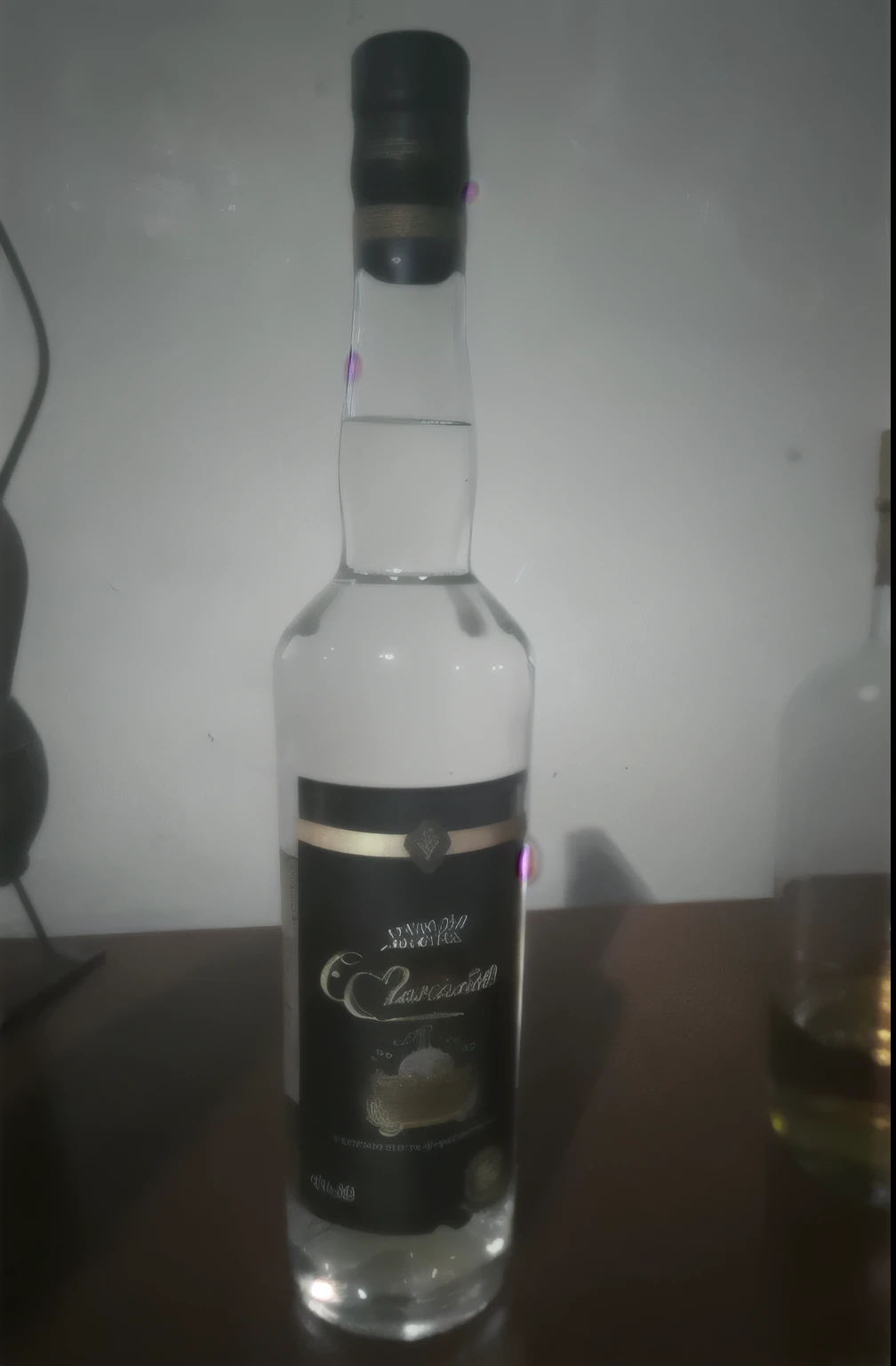 hay una botella de alcohol sobre una mesa al lado de una botella de licor, aguardiente, very fancy botella de whisky, vodka, botella de vodka, whisky, paralelo, fancy botella de whisky, botella de whisky, imagen de listado, Ron, embriagadoramente borroso, barcelo tomas, 2 0, 20 years, ebrio, render corona