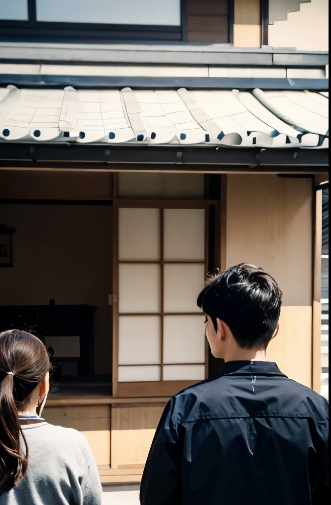 A male site manager in work clothes holding documents is having a meeting with a female client in front of a modern Japanese house.。Both the female customer and the on-site manager are seen from behind, and the on-site manager is explaining to her.、The photo is taken at a camera angle that allows you to see a little of the face.。Both the customer and the site manager are Japanese.、I&#39;m about 40 years old。realistic pictures