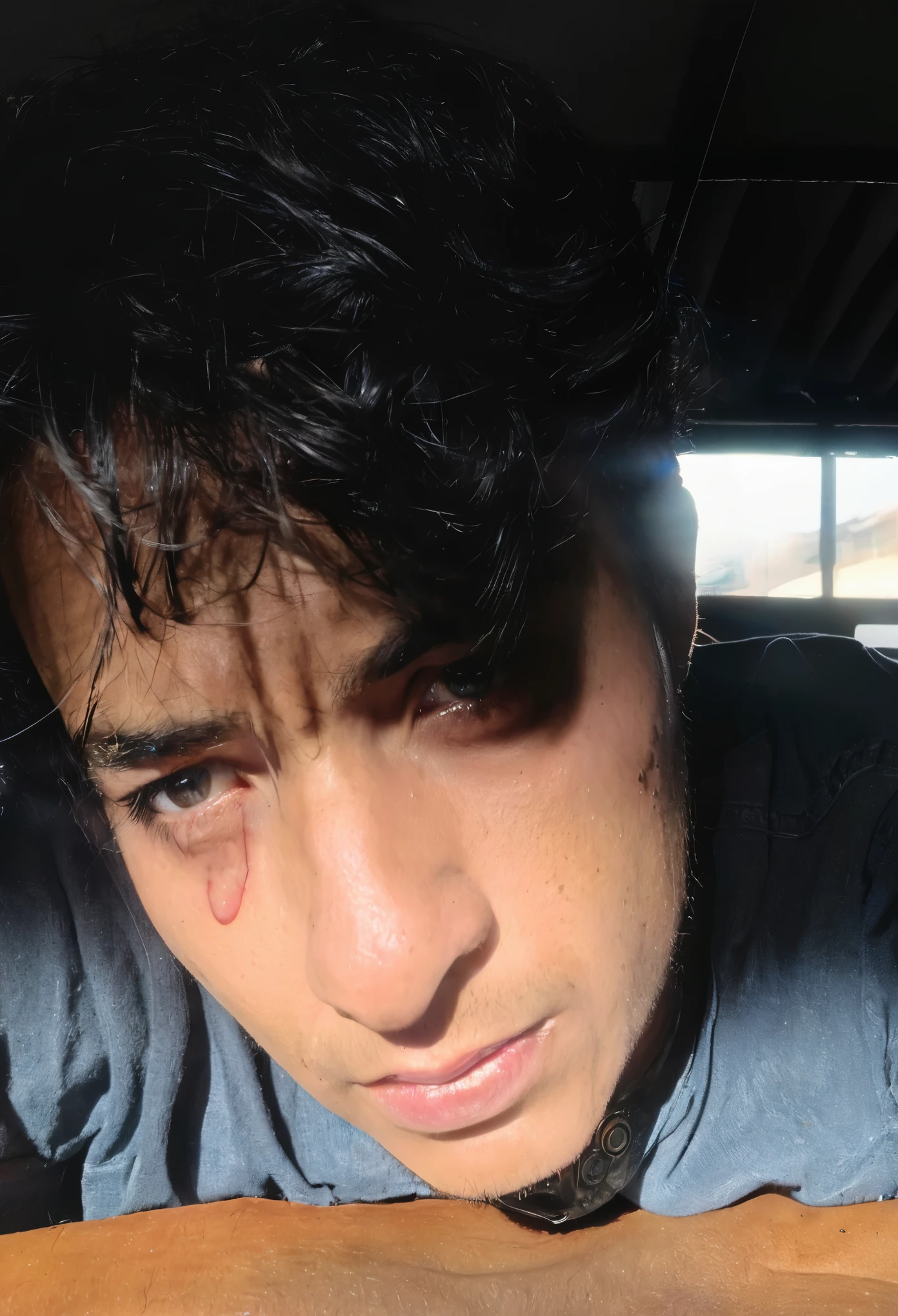 There is a man who is looking at a cell phone, with a cara magullada and bruises, cara dura y guapa, imagen de muy muy alta calidad, cara tersa, ojos pesados hacia un lado, around 19 years, Help me, eso es todo, captured with sony a7 camera, cara muy detallada y perfilada, mirada seria y triste en sus ojos, foto de perfil