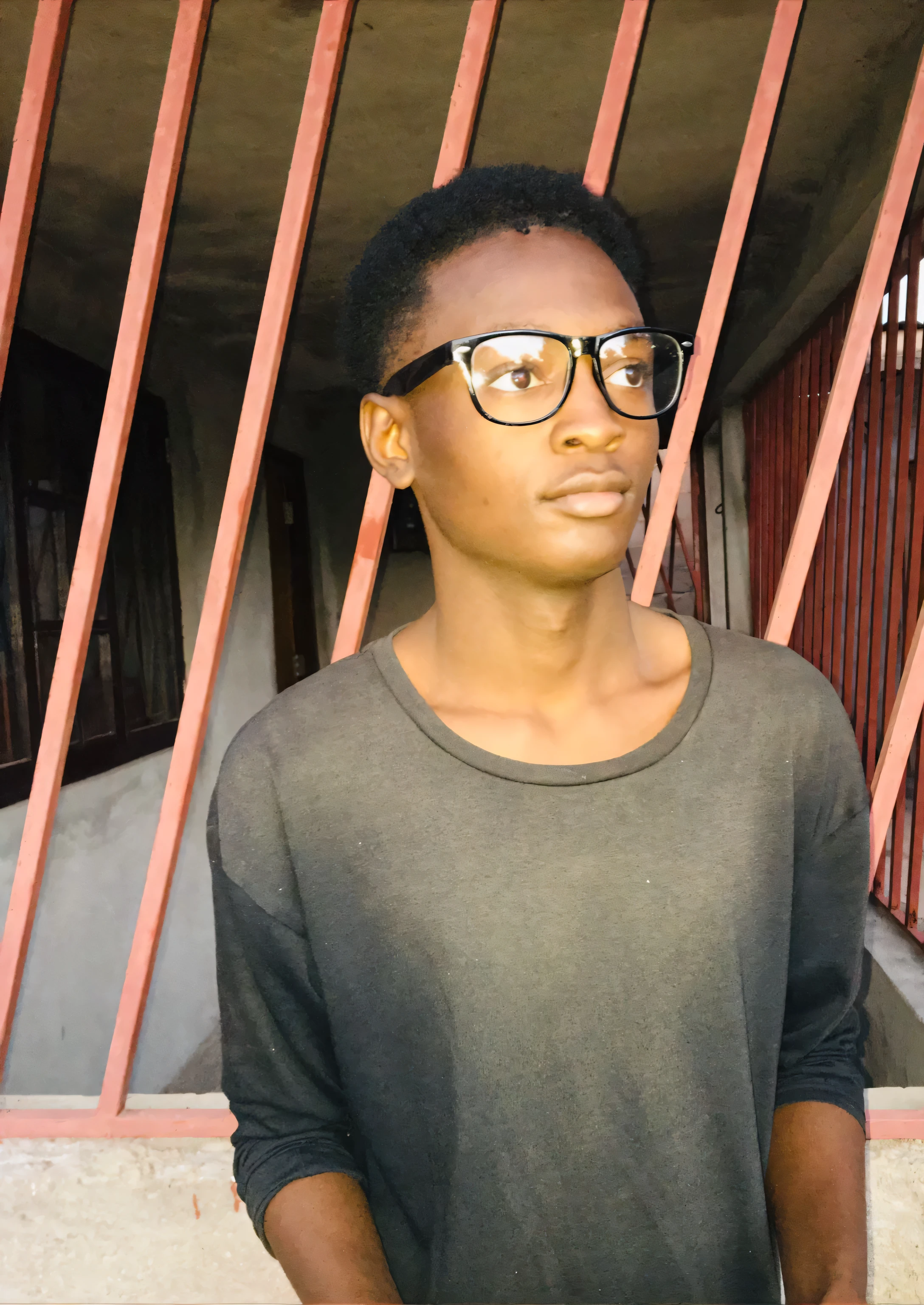 there is a man with glasses standing in front of a red fence, inspired por Chinwe Chukwuogo-Roy, David Uzochukwu, por Chinwe Chukwuogo-Roy, Godwin em particular, Riyad Cassiem, adolescente negro, Prince Adebanji, ele tem cerca de 16 anos
