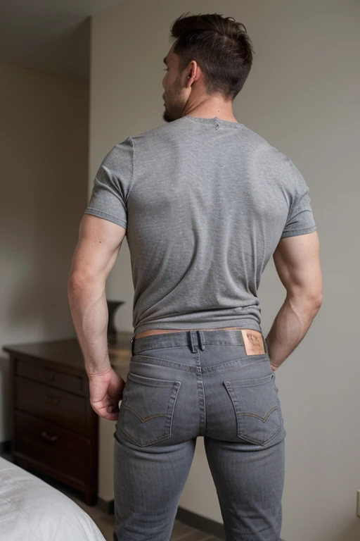 mature atlethic manly man wearing gray jeans , full body, with his back turned