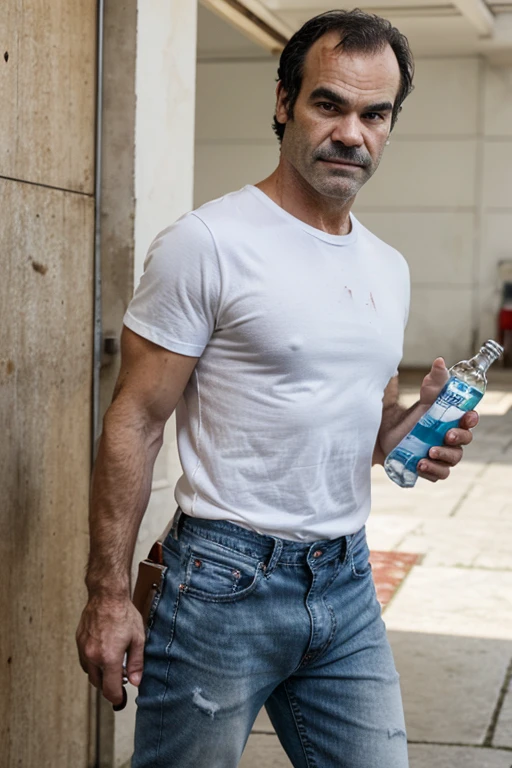 steven ogg in bloody white tee shirt and jeans holding alcohol bottle