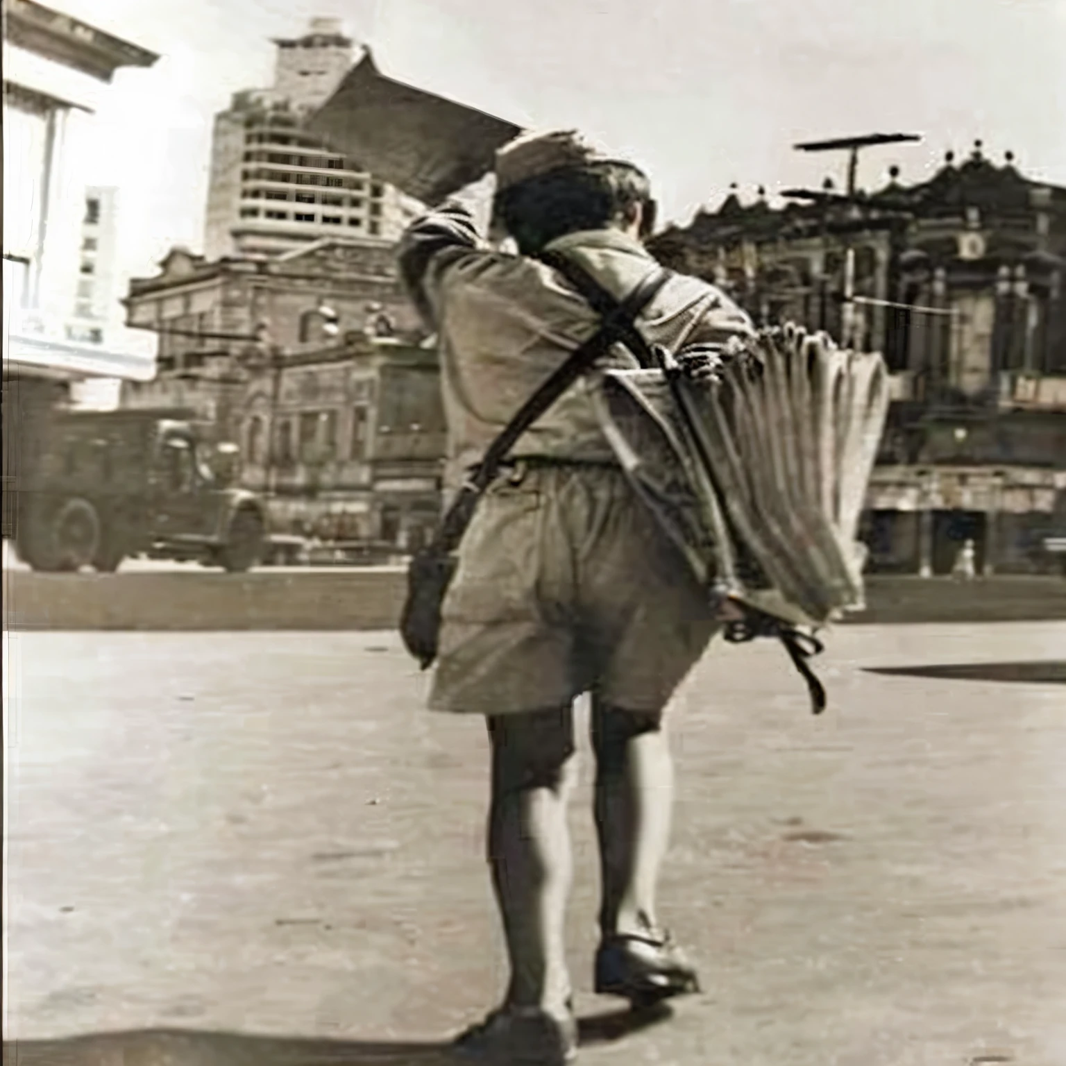 arafed man carrying a large umbrella in a city square, japan soldier in world war 2, hong kong 1 9 5 4, inspired by Alfred Eisenstaedt, tourist, by Sun Junze, carrying a guitar, by John Keane, carrying mosin on back, by Shigeru Aoki, historical photography, fan ho photography, post war style, carrying a rifle