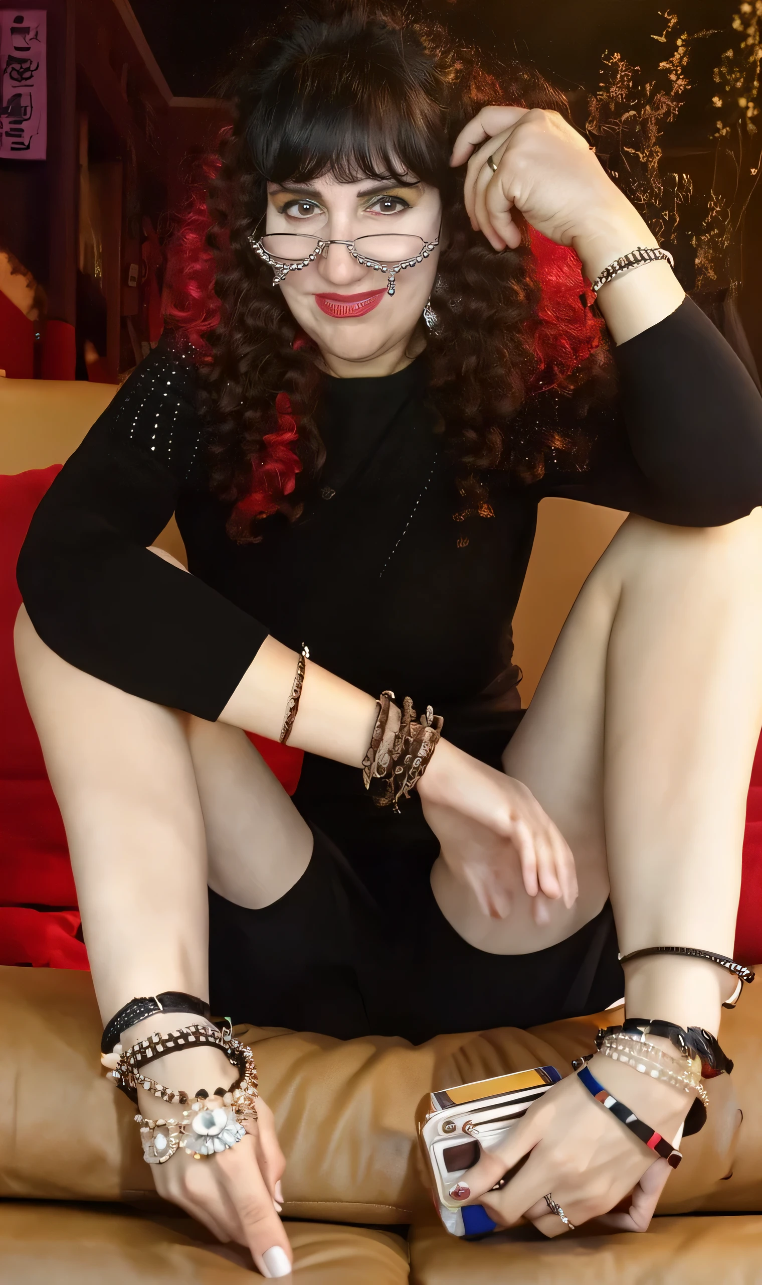 Woman’s right hand, wearing rings and bracelets, holding a glass of wine,