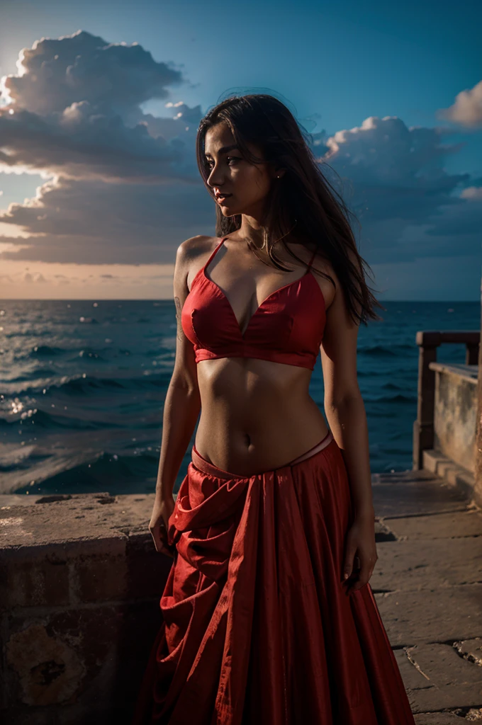 A sexy girl wearing a red lehenga infront of a dark sea