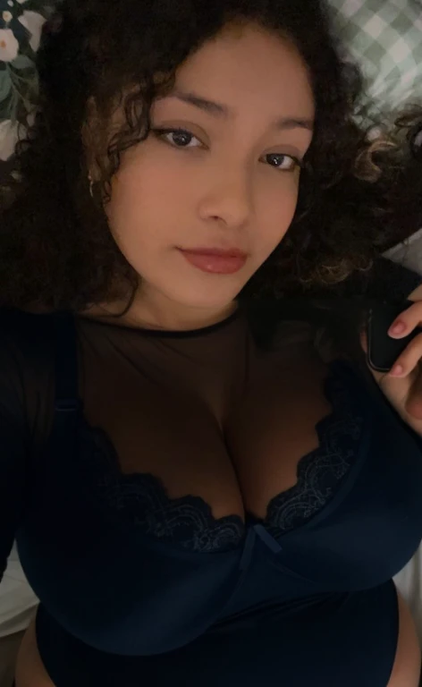 there is a woman laying in bed with a cell phone, taken in the early 2020s, profile image, around 1 9 years old, selfie of a young woman, 18 years old, alanis guillen, headshot profile picture, profile pic, 30 years old woman, 3 0 years old woman, her face framed with curls, Big tits, huge tits, no clothes, sexy, cute, minimal clothes, thick, bbw, chubby stomach, thick nipples, nipple piercings, large areola, hard nipples, piercing through shirt, nipples hard through shirt, busty, major cleavage, naked, ripping through top, spilling over sides, bra too tight, giant tits, extra wide hips, upper body zoom in, showing off huge , fat stomach, see through top, fat bbw, large areola showing, major cleavage, latina, down to stomach, wide hips, sexy, upper body zoom, thick arm, showing off , top half only, showing only upper, only a bra, showing off cleavage
