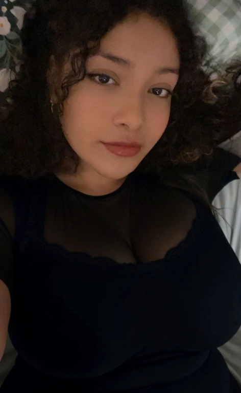 there is a woman laying in bed with a cell phone, taken in the early 2020s, profile image, around 1 9 years old, selfie of a young woman, 18 years old, alanis guillen, headshot profile picture, profile pic, 30 years old woman, 3 0 years old woman, her face framed with curls, Big tits, huge tits, no clothes, sexy, cute, minimal clothes, thick, bbw, chubby stomach, thick nipples, nipple piercings, large areola, hard nipples, piercing through shirt, nipples hard through shirt, busty, major cleavage, naked, ripping through top, spilling over sides, bra too tight, giant tits, extra wide hips, upper body zoom in, showing off huge , fat stomach, see through top, fat bbw, large areola showing, major cleavage, latina, down to stomach, wide hips, sexy, upper body zoom, thick arm, showing off , top half only, showing only upper, only a bra, showing off cleavage