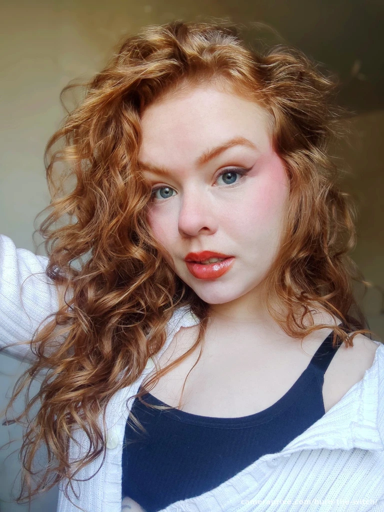 there is a woman with long red hair and a white shirt, with curly red hair, curly red hair, red curly hair, red curled hair, pale skin curly blond hair, ginger wavy hair, ginger hair with freckles, curly copper colored hair, curly blonde hair | d & d, red hair and freckles, dirty red wavy hair, with red hair