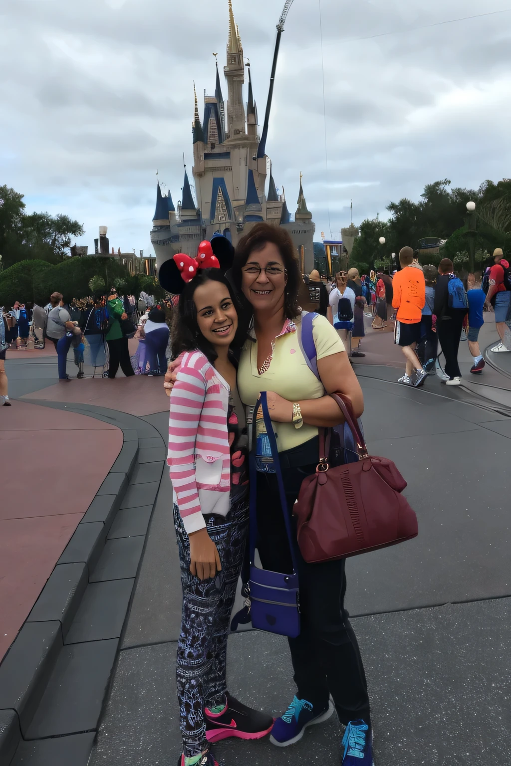 there are two women standing in front of a castle with a purple purse, disney world, magic kingdom, in disney, walt disney world, background is disneyland castle, castle in background, disney land, castle in the background, disney!!, ( castle in the background ), disney 8 k photo, with a castle in the background, disneyland as backdrop, with towers