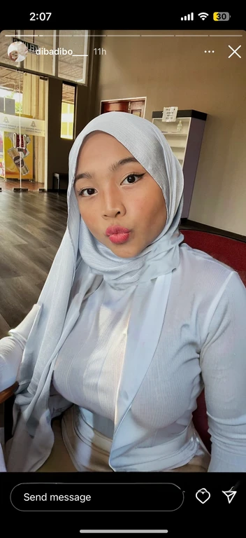 (best quality,4k,8k,highres,masterpiece:1.2),ultra-detailed,realistic,portrait,hijabi,sitting down, sexy, alluring figure, thick thighs, tight white office shirt, low neck shirt, long sleeves, little cleavage