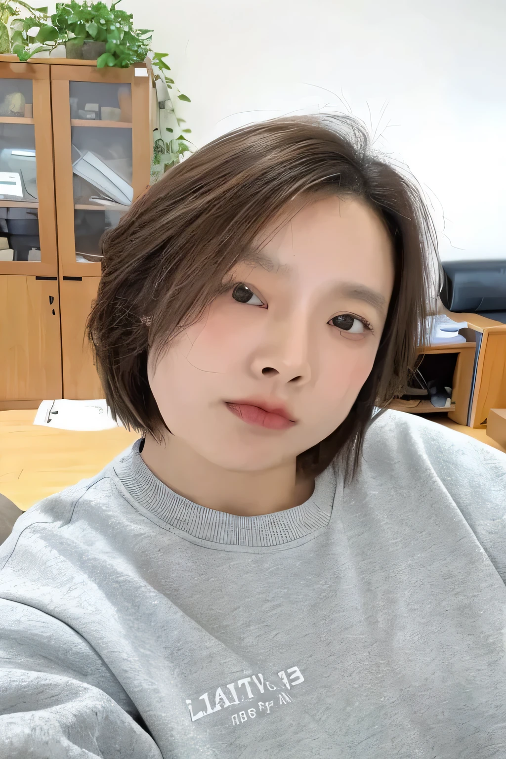 Arafed woman in grey sweatshirt sitting in room, short hair, Cui Xianhua, Minami Zaiwa, Guo Zhiying, 8k selfie photos, without make-up, round face, 30 year old female, 30-year-old woman, Jung Sang-soo, Have a small nose, 38 years old, Shin Min Jung