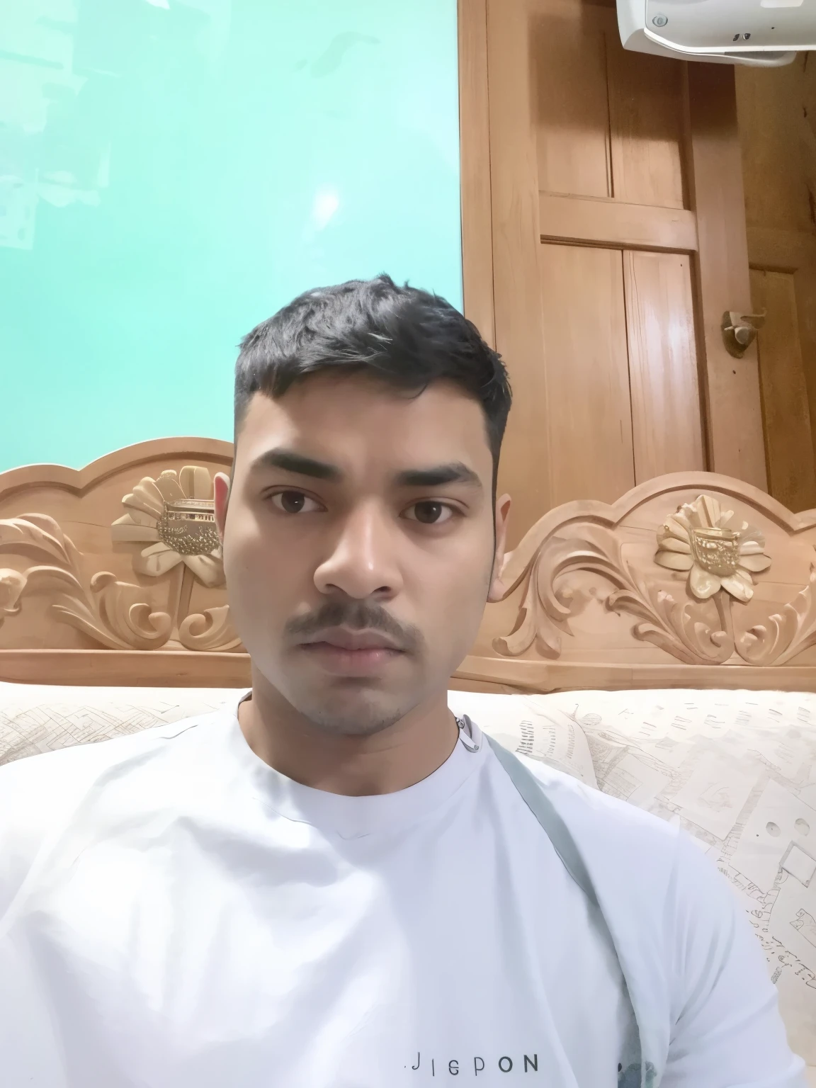 there is a man sitting on a couch with a white shirt, around 1 , with accurate face, front profile!!!!, without beard, face picture, with kind face, selfie photo, old picture, jayison devadas, without helmet, ayan nag, face photo, without beard and mustache, profile picture, clean shaven face