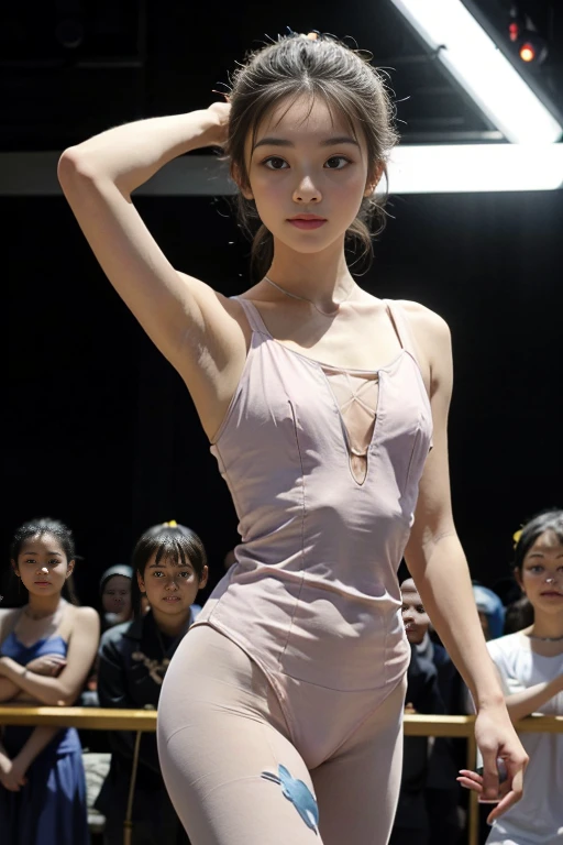 Beautiful and slender ballerina, wearing a pink leotard, is in an alluring pose in front of a cheering audience.