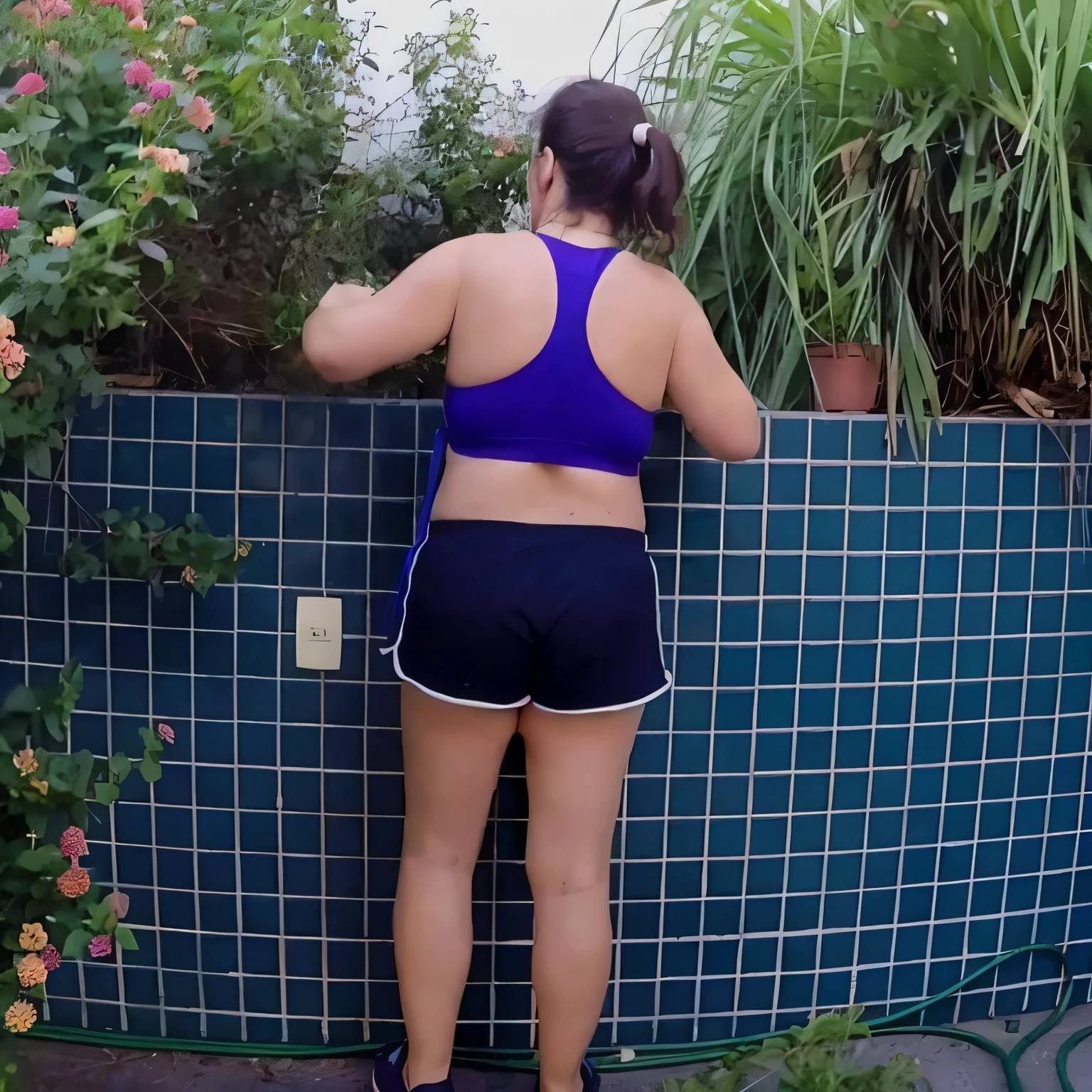there is a woman standing next to a wall with flowers, back - shot, sport bra and dark blue shorts, squatting down next to a pool, fit pic, seen from the back, back pose, waist - shot, back shot, backview, shot from the back, sport bra and shorts, hunched shoulders, rear-shot, backshot. Best quality , high resolution, Masterpiece: 1.3, A high resolution, (photographically realistic), Beautiful girl, Sexy Pose, 8K, NFSW, fitness body, sports bra and dark blue shorts, toned legs. She is around 35 years old, a woman in good physical condition. Masterpiece, best quality, (best quality), realistic lighting, 8k.