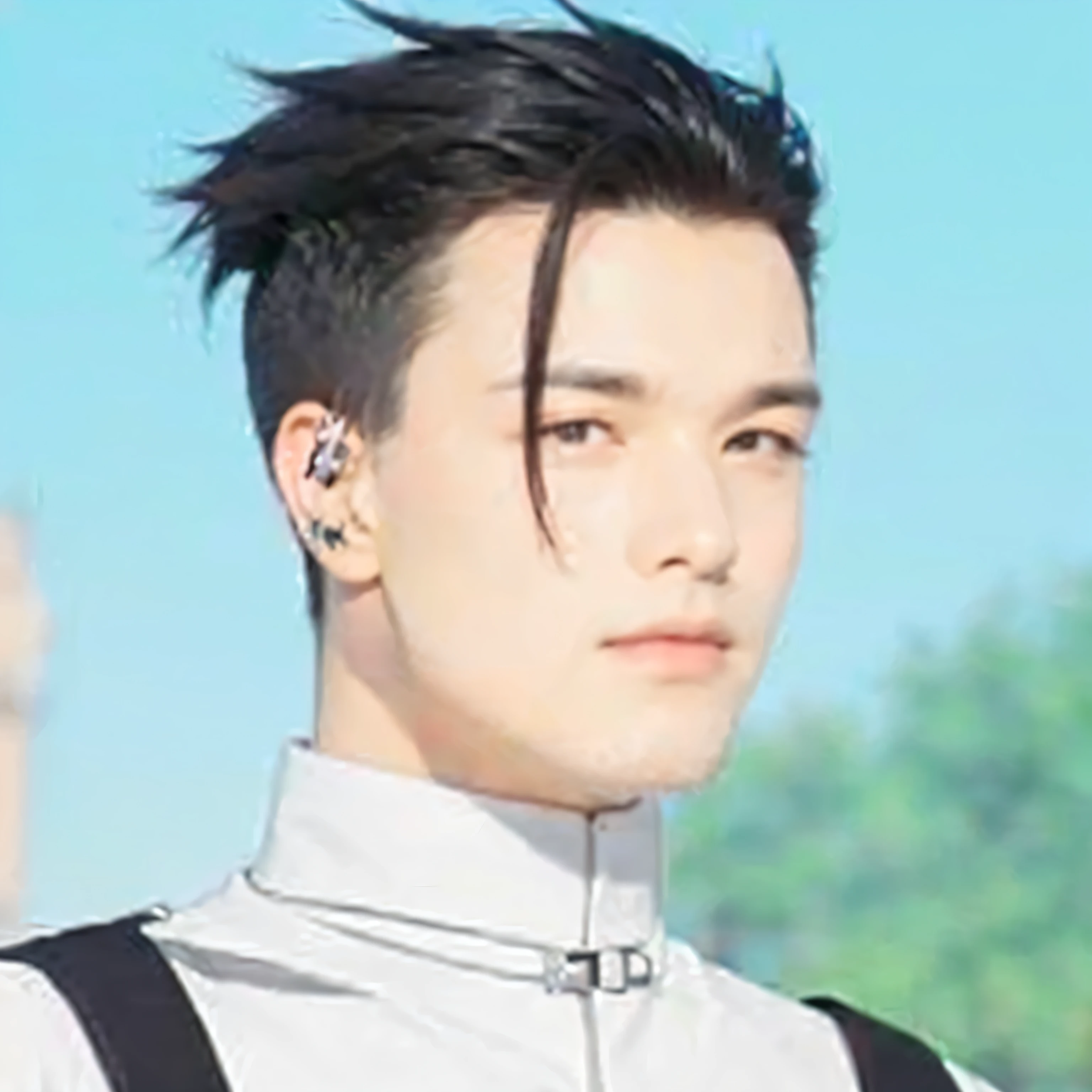 Man, short black hair slicked back, white coat with black cuffs