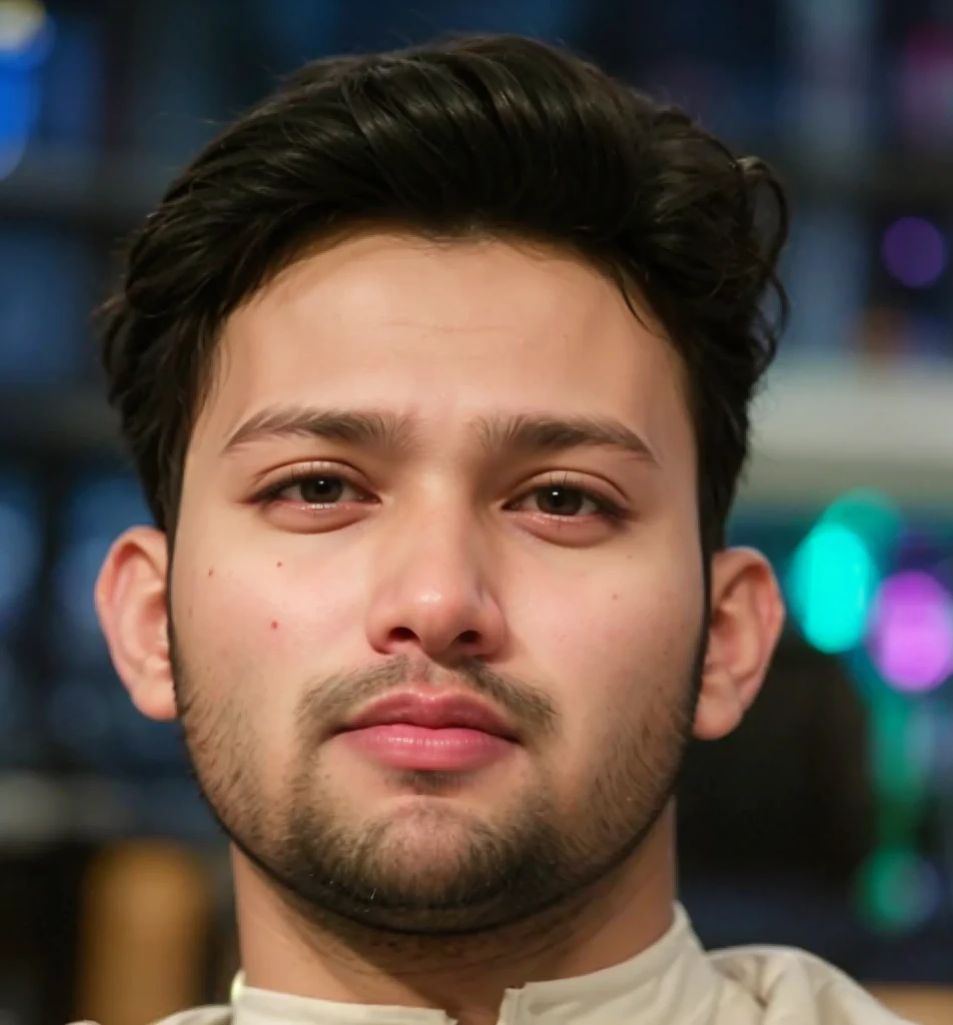 A beautiful young bearded man with highly detailed skin looking at the camera,8k,high res, soft light,no contrast,ultra realistic, photorealism.((real life photo,realistic:1.9, short beard:1),((closeup shot:1.5))