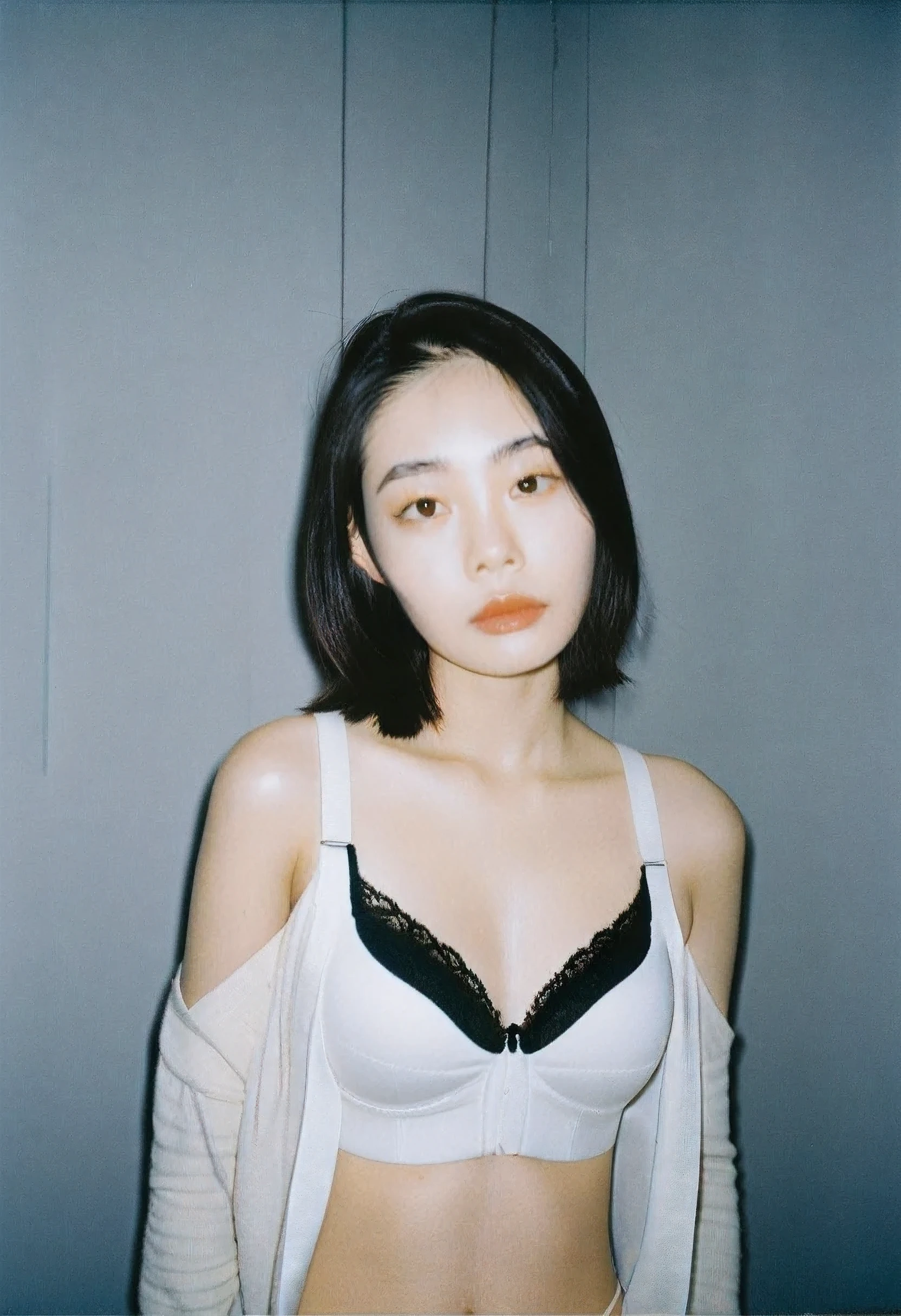  thai girl , 18-21 years old , White shirt, unbuttoned, open at the shoulders show black bra, black hair , high-quality photo portrait , shot on a Polaroid camera , double eyelid --ar 34:65 --style raw