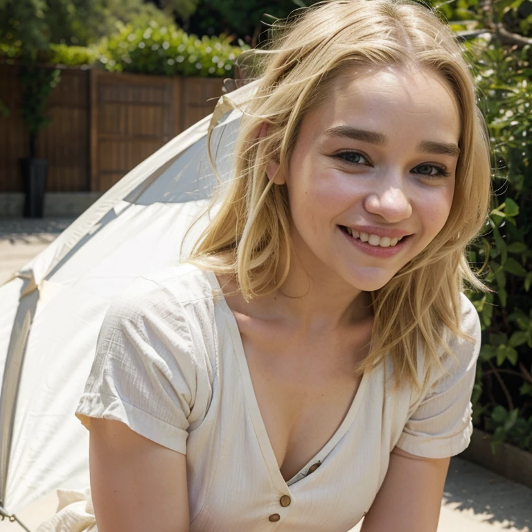 Emilia Clarke with dyed blonde hair in summer weather dressed in light clothing smiling
