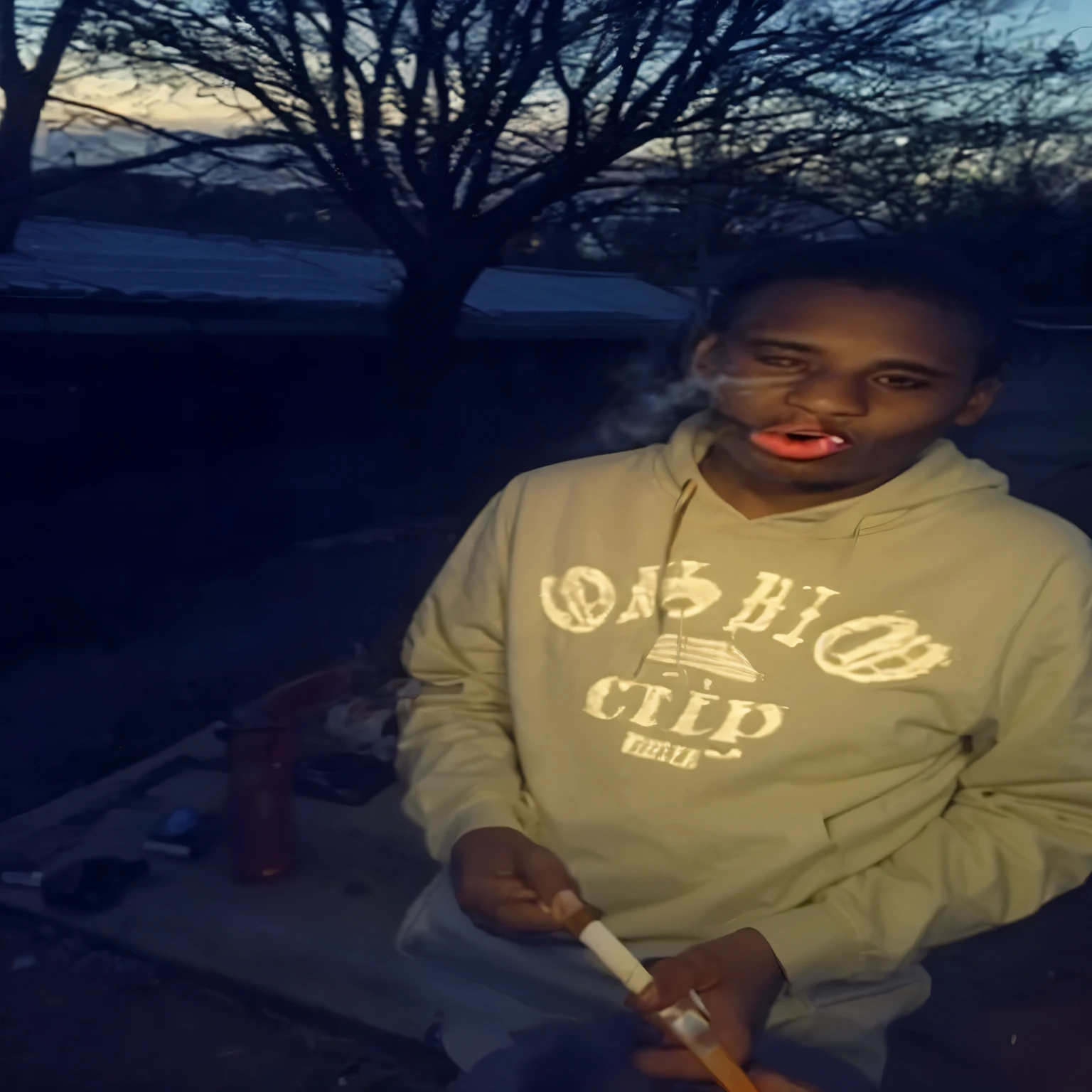 Insert a smoking joint into the mouth of the person in the photo