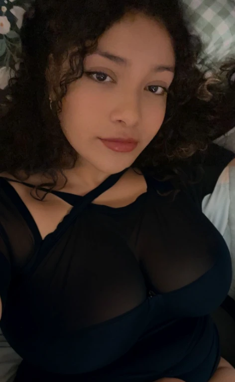 there is a woman laying in bed with a cell phone, taken in the early 2020s, profile image, around 1 9 years old, selfie of a young woman, 18 years old, alanis guillen, headshot profile picture, profile pic, 30 years old woman, 3 0 years old woman, her face framed with curls, Big tits, huge tits, no clothes, sexy, cute, minimal clothes, thick, bbw, chubby stomach, thick nipples, nipple piercings, large areola, hard nipples, piercing through shirt, nipples hard through shirt, busty, major cleavage, naked, ripping through top, spilling over sides, bra too tight, giant , extra wide hips, upper body zoom in, showing off huge , fat stomach, see through top, fat bbw, large areola showing, major cleavage, latina, down to stomach, wide hips, sexy, upper body zoom, thick arm, showing off , top half only, showing only upper, only a bra, showing off cleavage