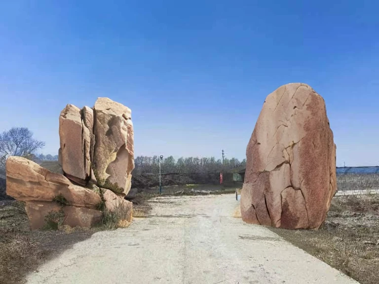 The photo is realistic and symmetrical. There is a rockery on both sides of the road.,