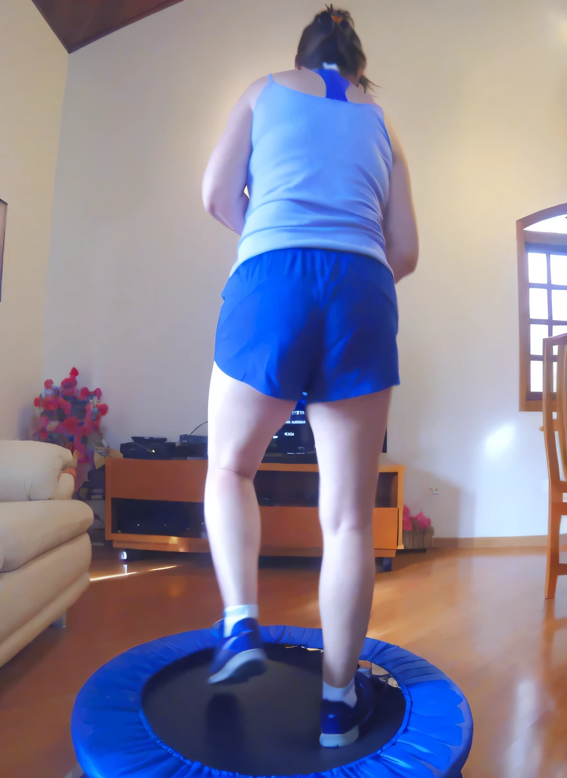 woman standing with her back on a trampoline in a living room with a sofa, jumping, dancing woman, in action pose, triumphant pose, full figure close-up. Wearing blue shorts and a blue top. Slim body, slim waist. Her body exudes glamor and her face is the definition of beauty. Test, highly realistic, reddish skin, beautiful, slightly full lips, red lipstick, feeling of lightness and joy, hyper-realism, very elaborate skin, direct look. Full body photo, clear and high quality photo. Beautiful woman, extremely sexy, very sensual. Masterpiece: 1.3, high resolution, (photographically realistic), 8k, NUDE, NUDITY, NFSW.
